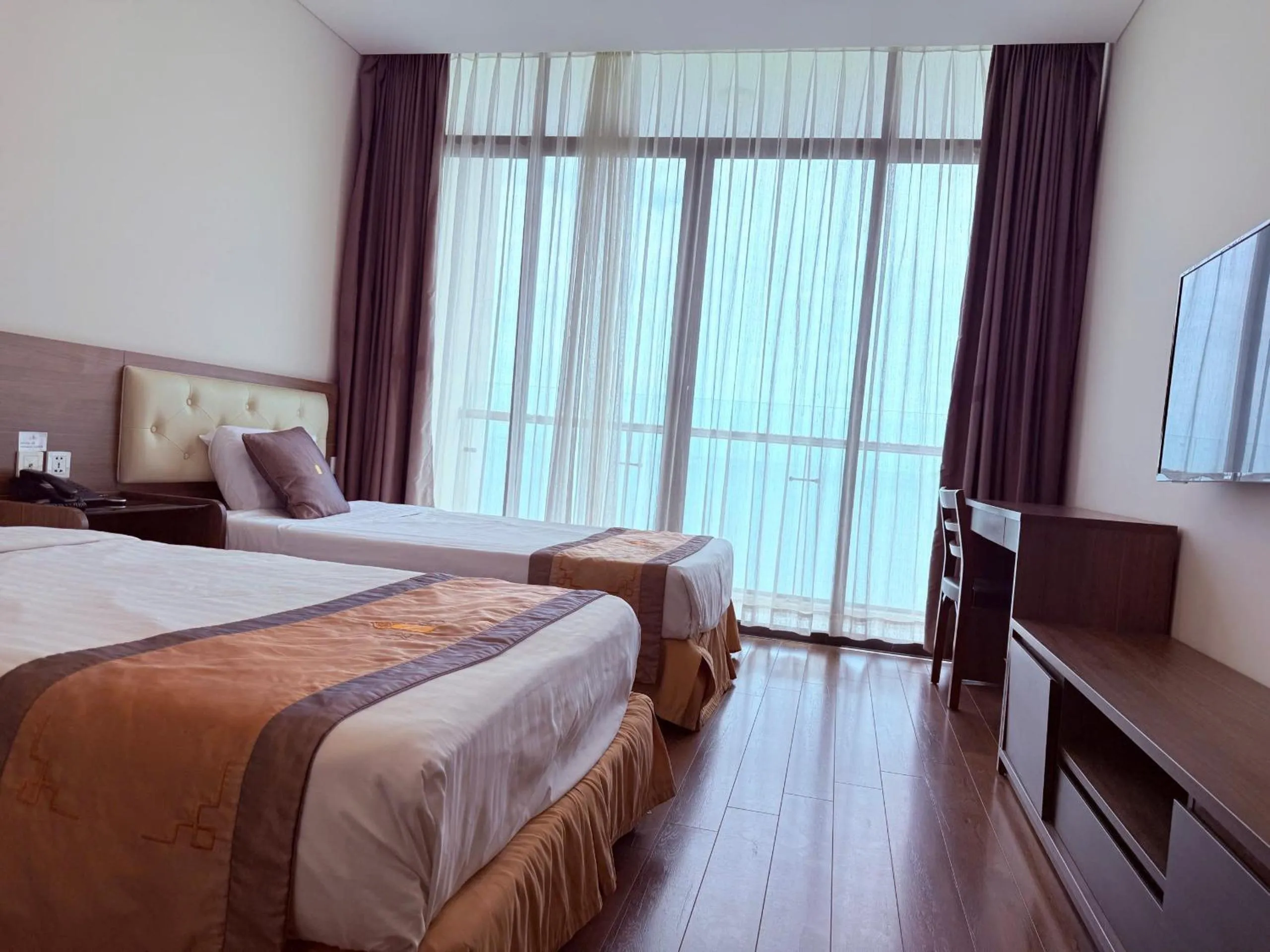 Communal lounge/ TV room, Bed in Lenid Ocean View Hotel