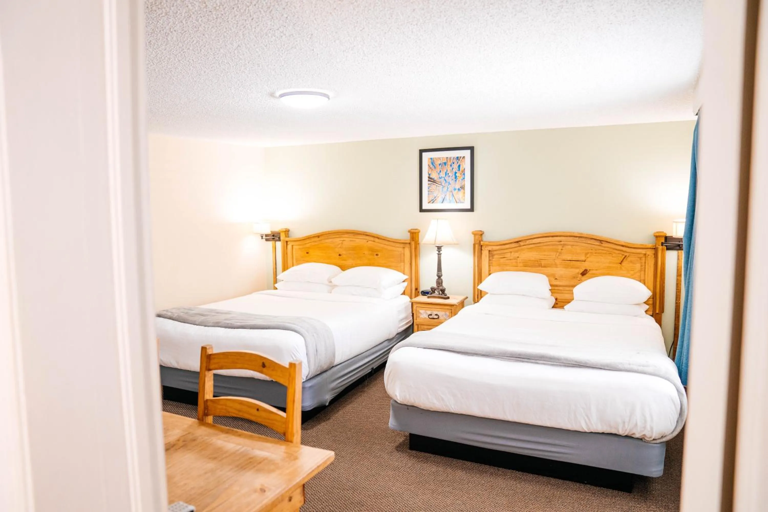 Bed in Salida Inn & Monarch Suites