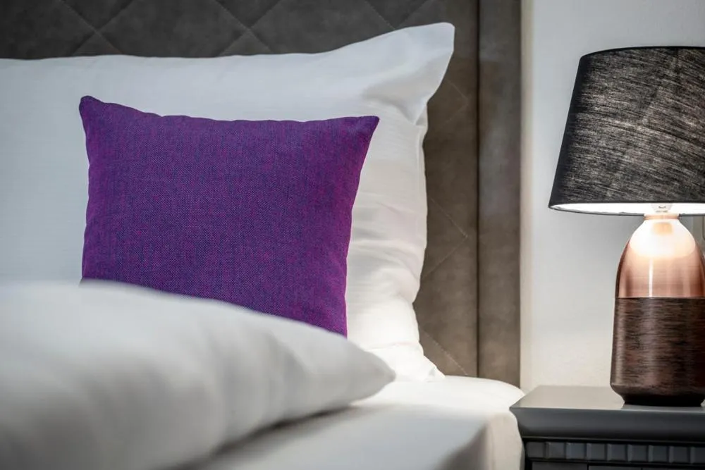 Bed in Arthur's Hotel und Apartments am Achensee