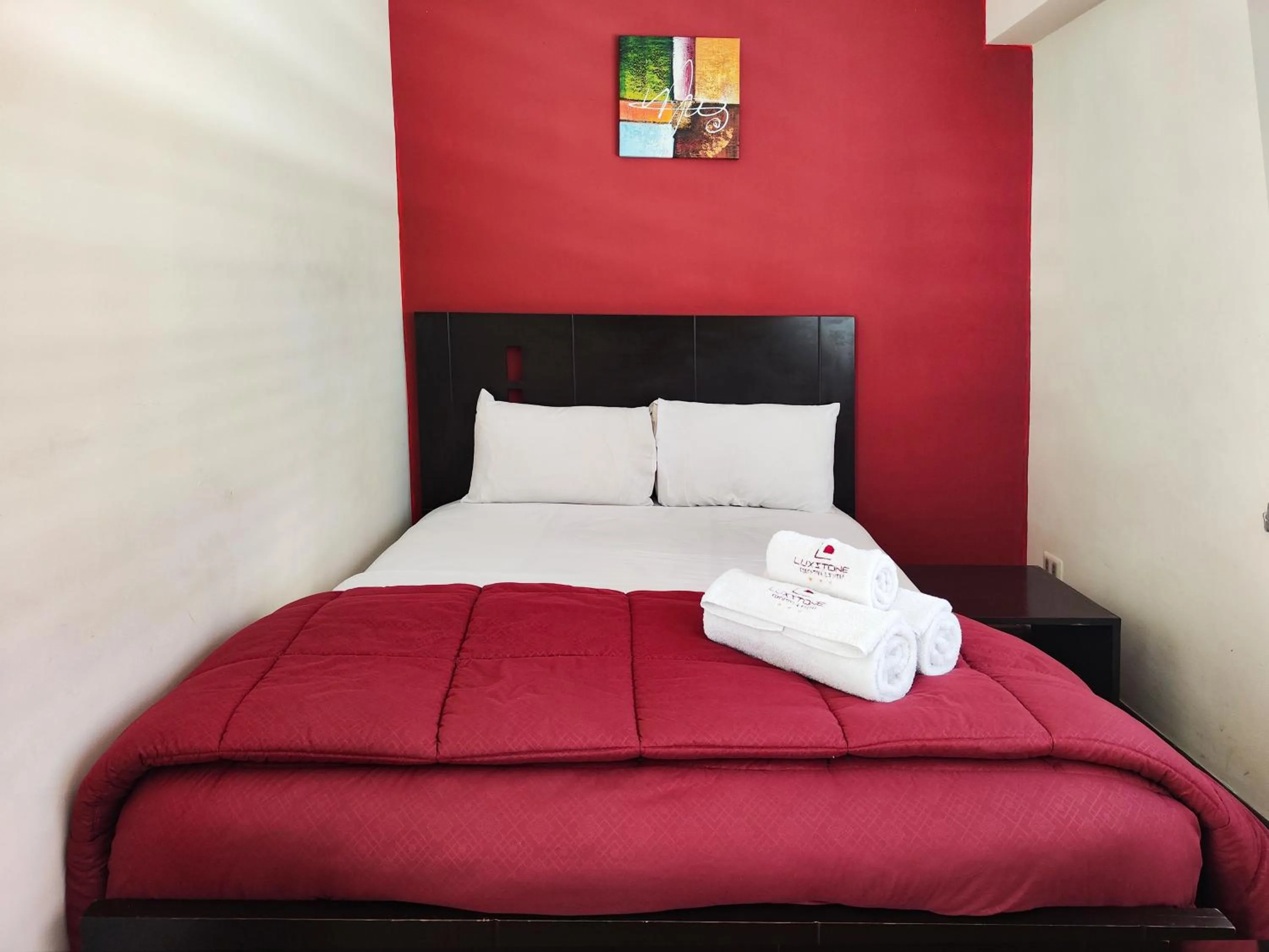 Bed in Luxstone Executive & Suites