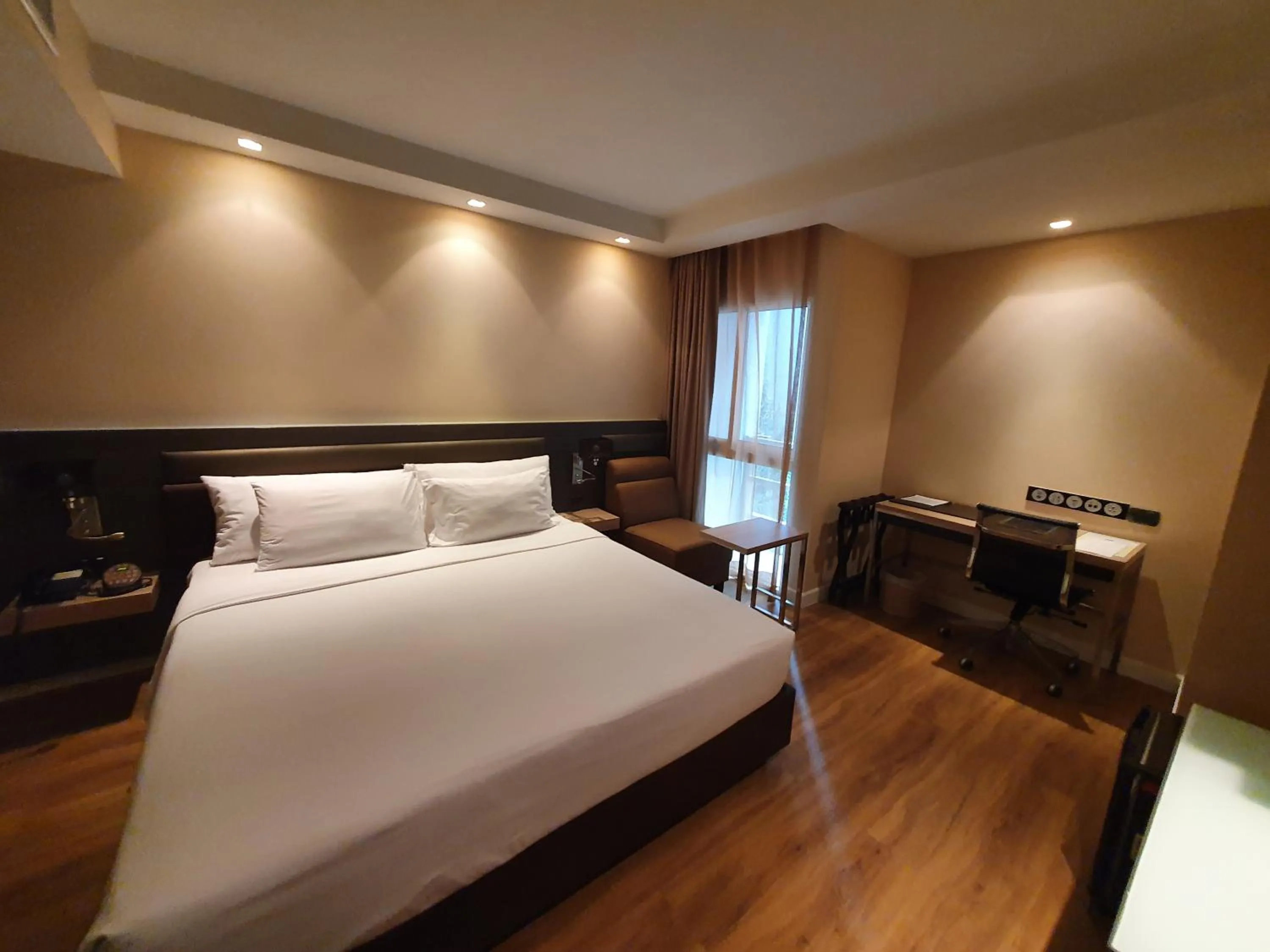 Bed in Amora NeoLuxe Suites Hotel
