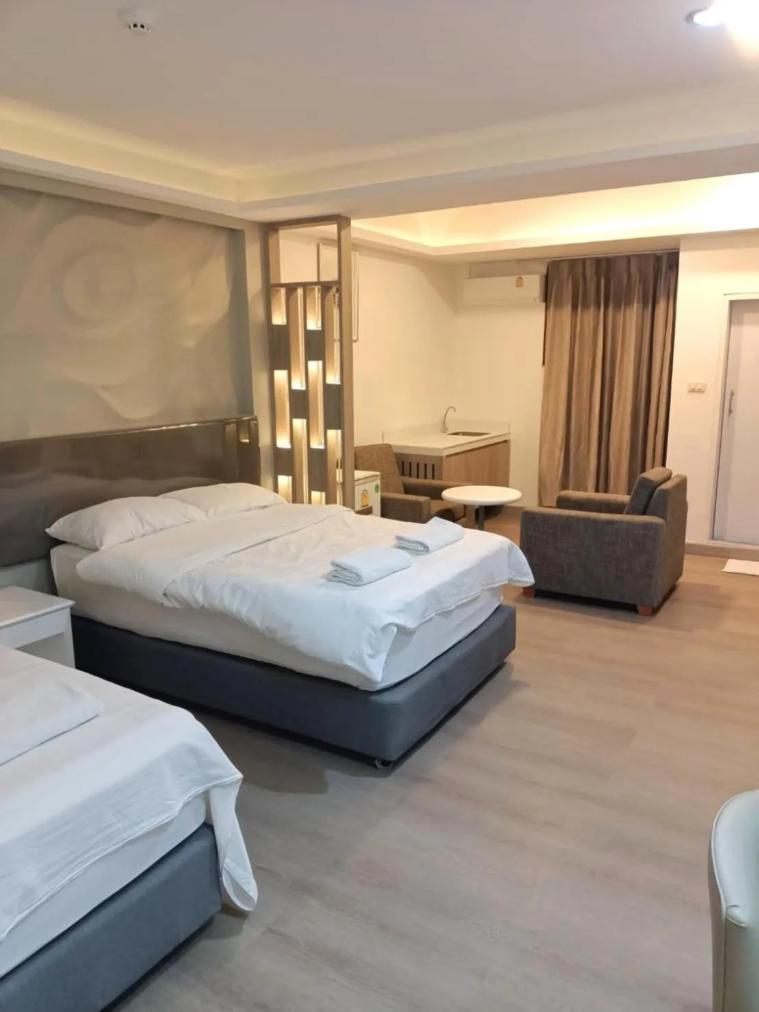 Bed in Royal Garden Home Hotel