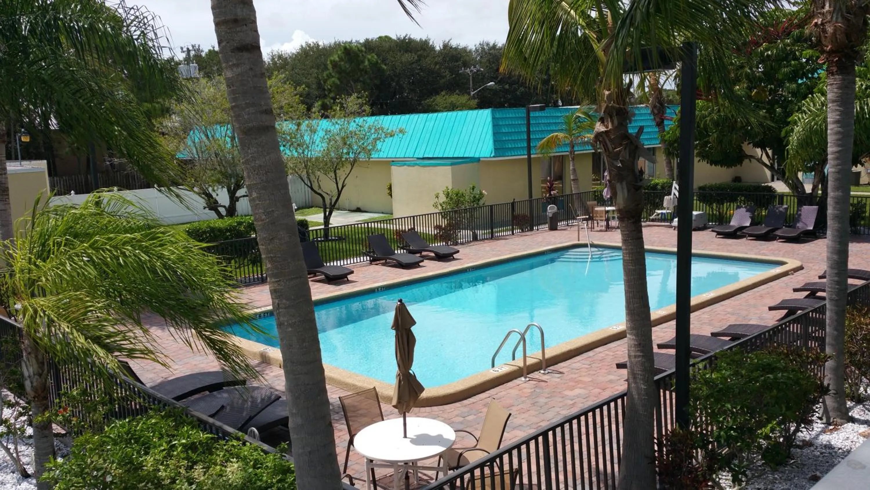 Swimming pool in Days Inn & Suites by Wyndham Fort Pierce Midtown