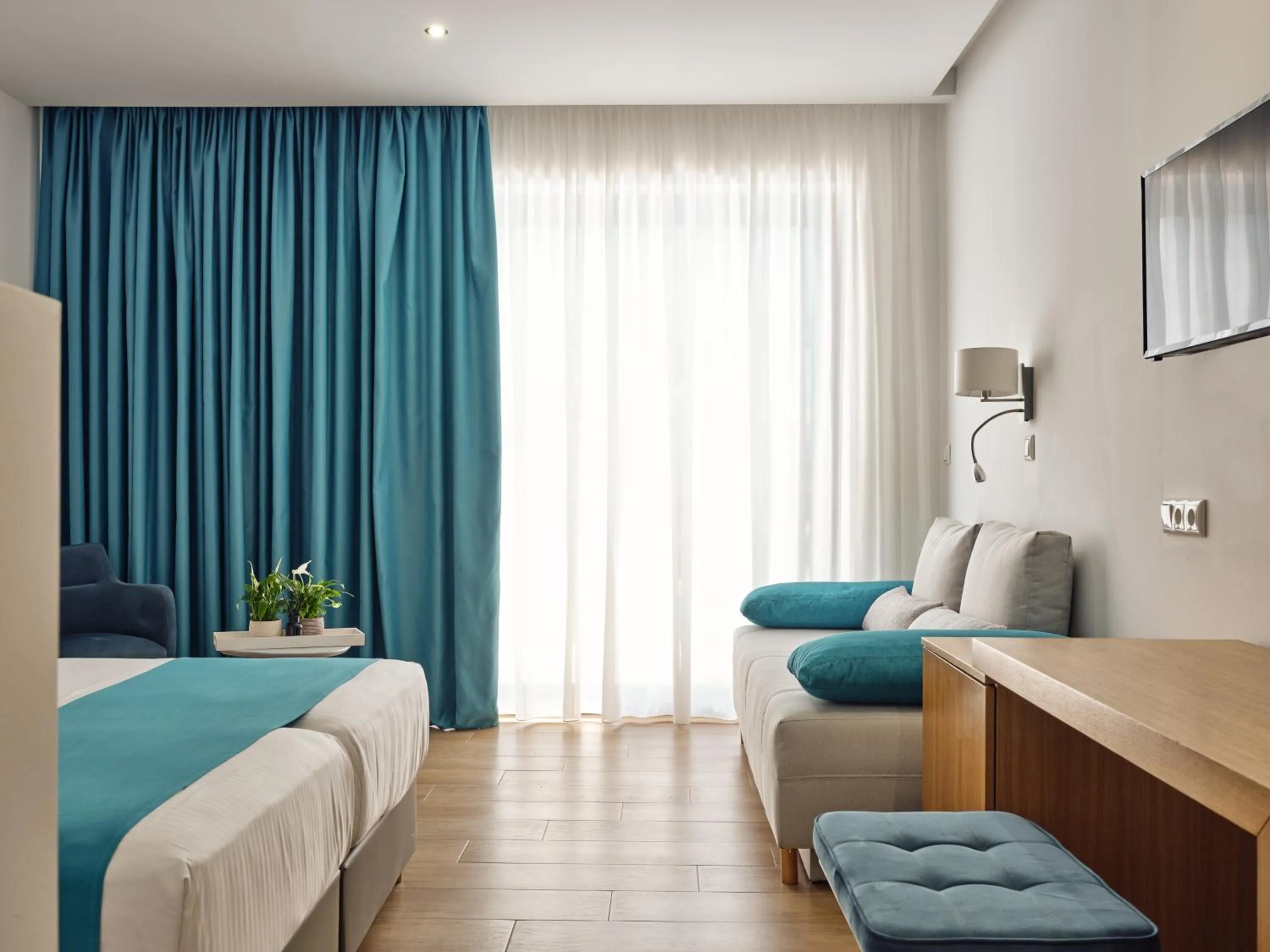 Living room, Bed in Cavo Orient Beach Hotel & Suites