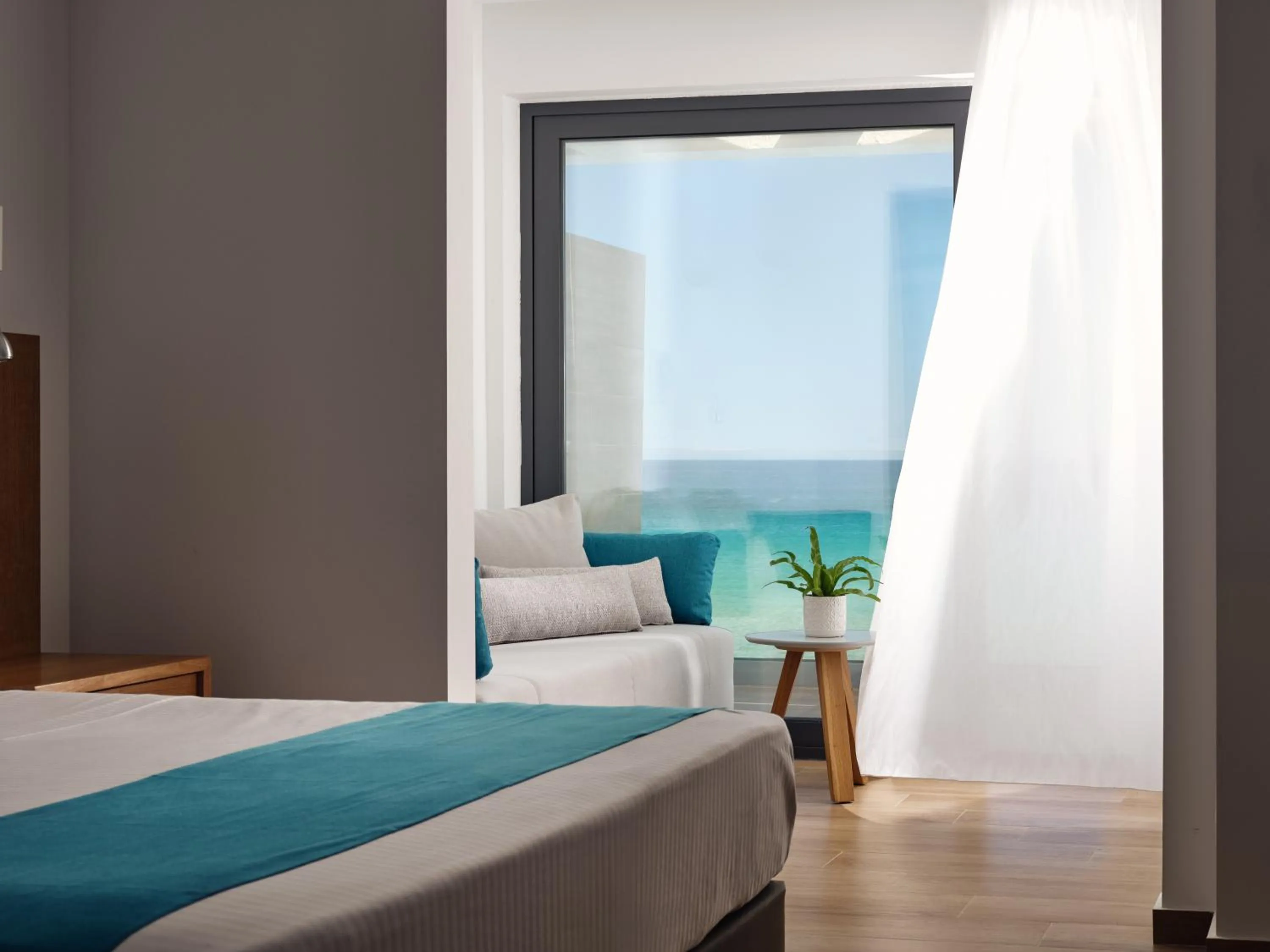 Bedroom, Bed in Cavo Orient Beach Hotel & Suites