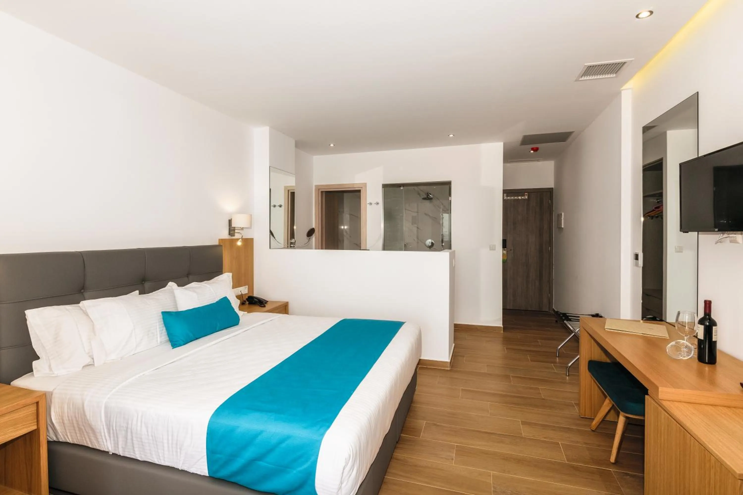 Photo of the whole room, Bed in Cavo Orient Beach Hotel & Suites