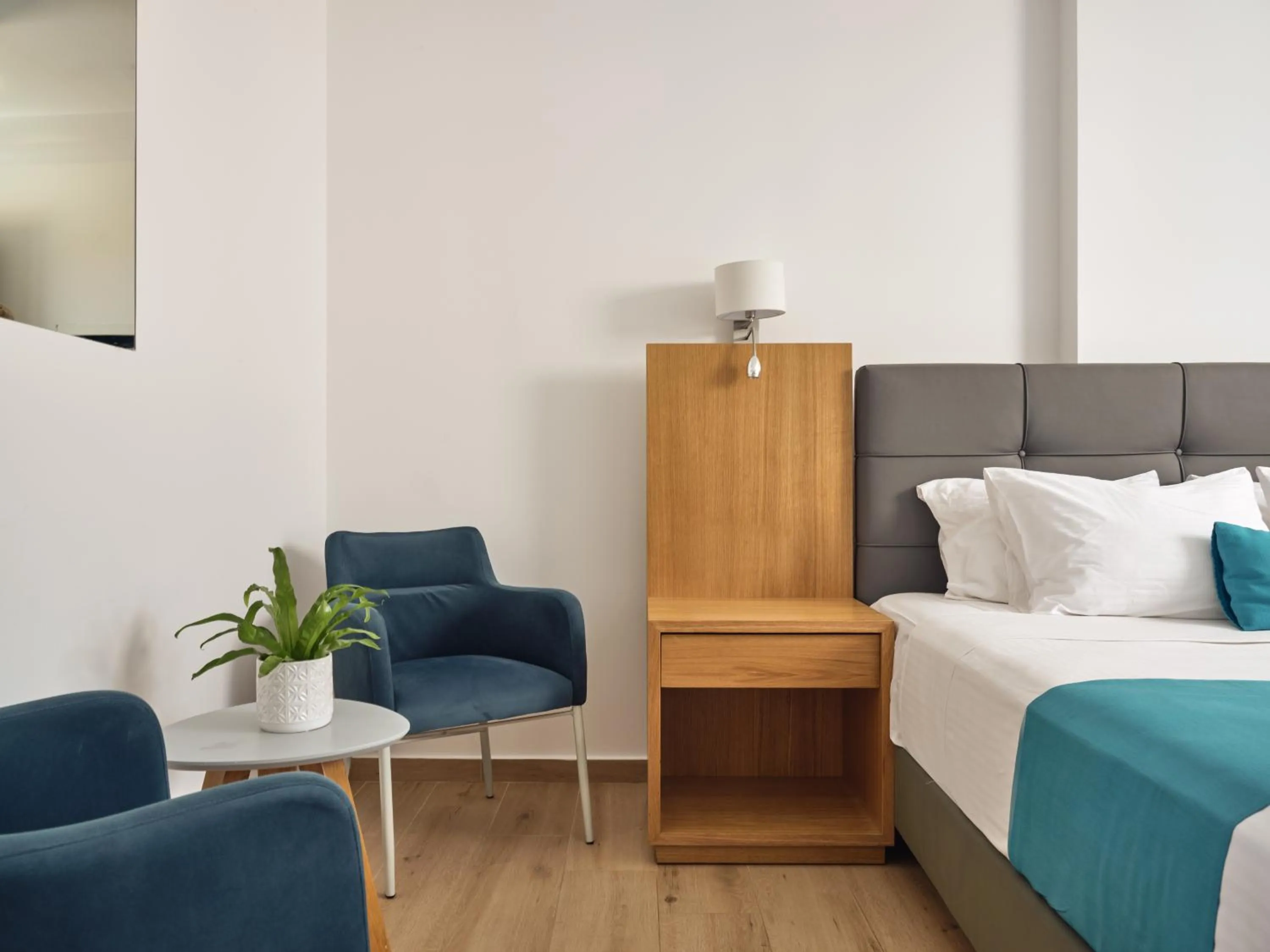 Seating area, Bed in Cavo Orient Beach Hotel & Suites