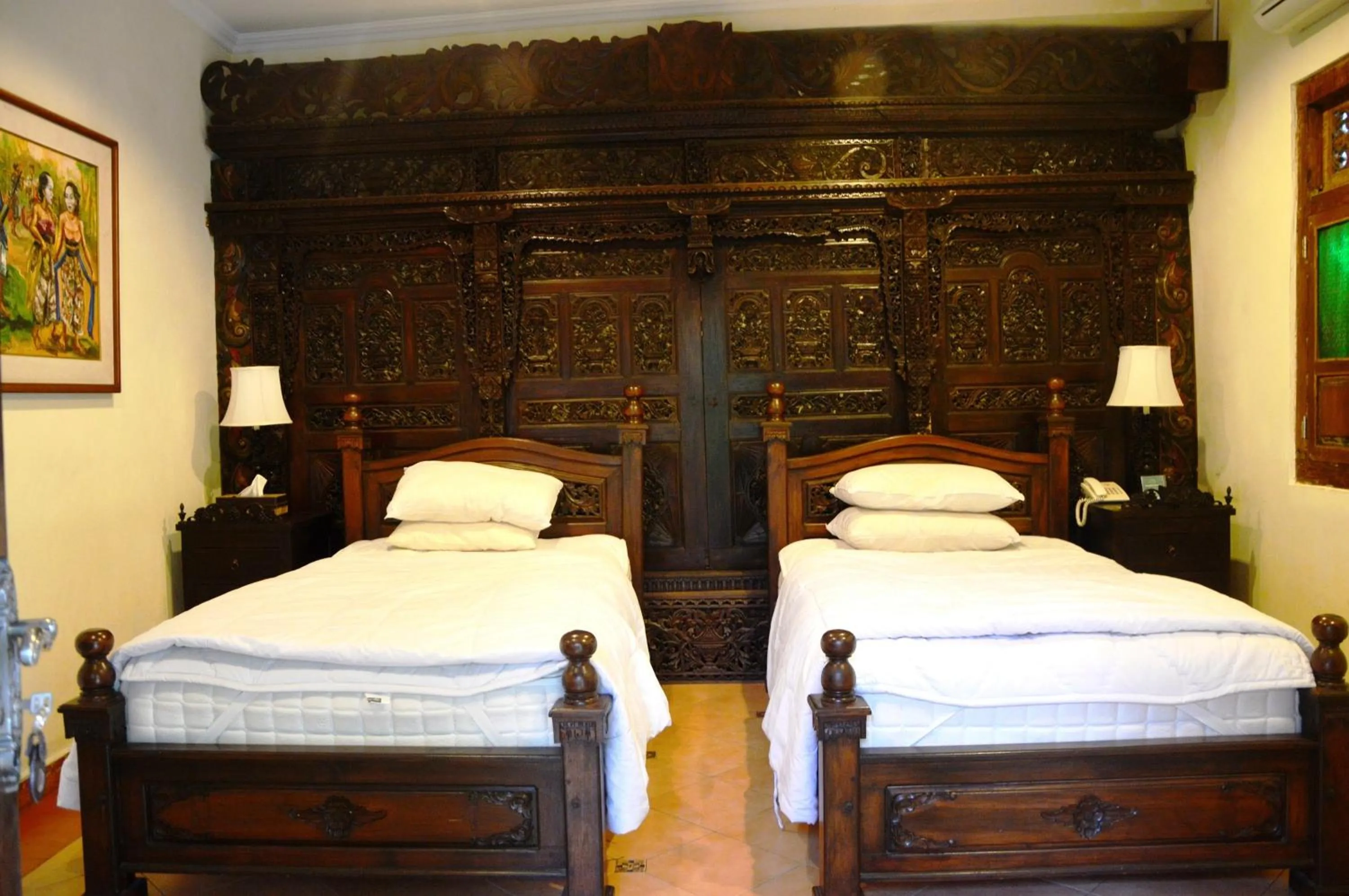 Bed in Joglo Plawang Villa & Resort
