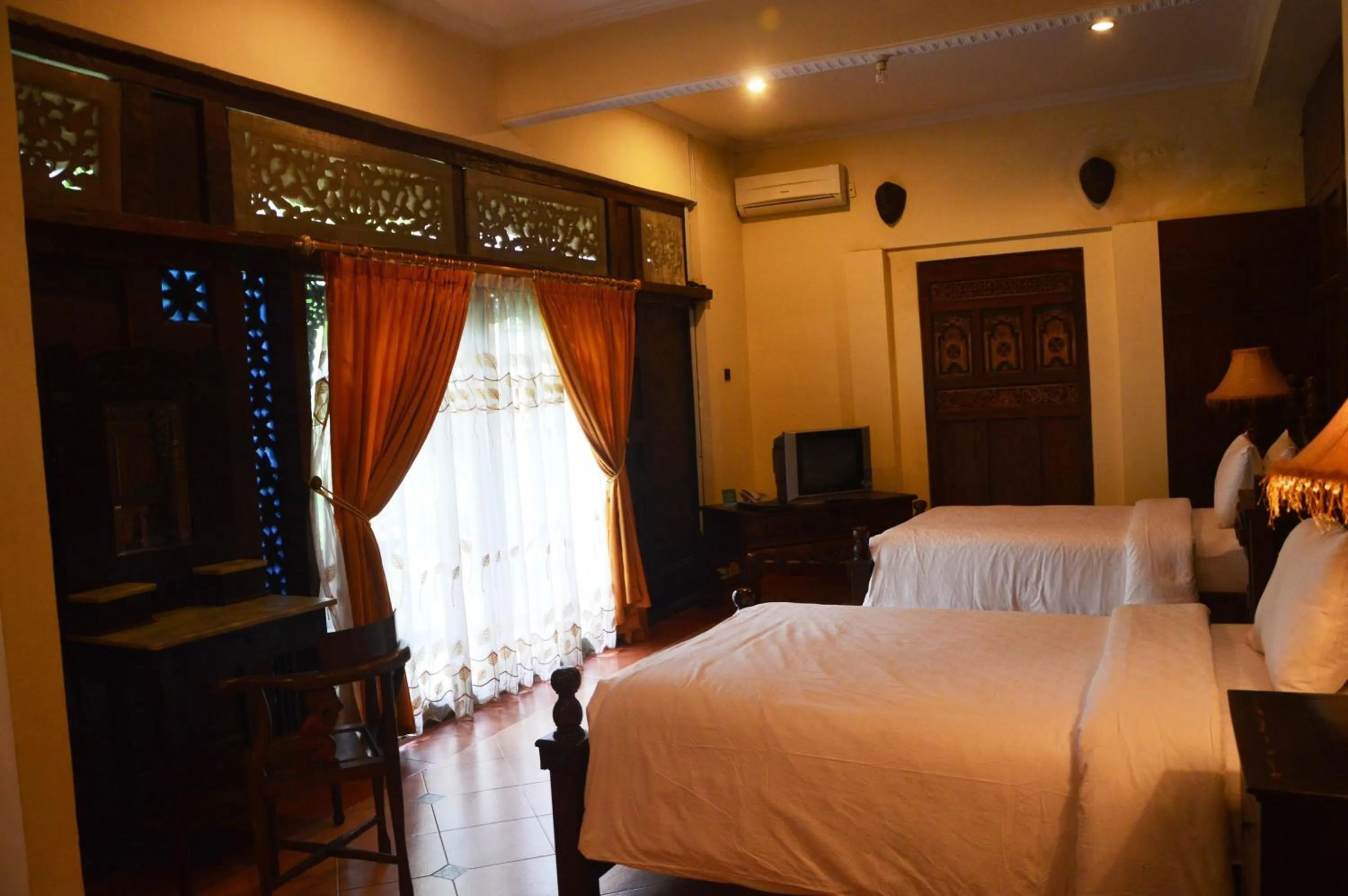 Bed in Joglo Plawang Villa & Resort