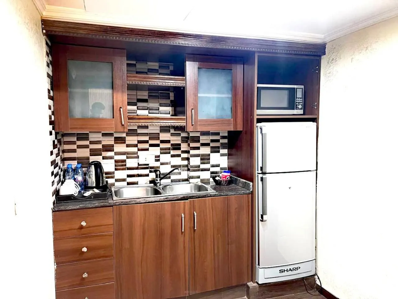 Kitchen or kitchenette in Queens Suite Hotel