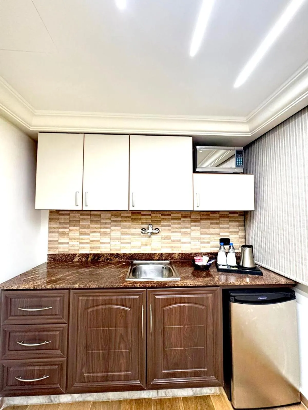 Kitchen or kitchenette in Queens Suite Hotel