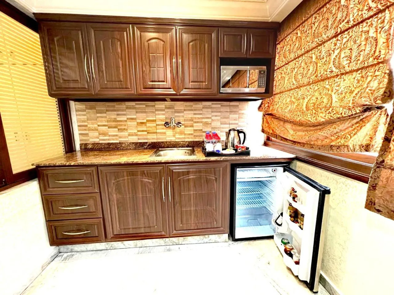 Kitchen or kitchenette in Queens Suite Hotel