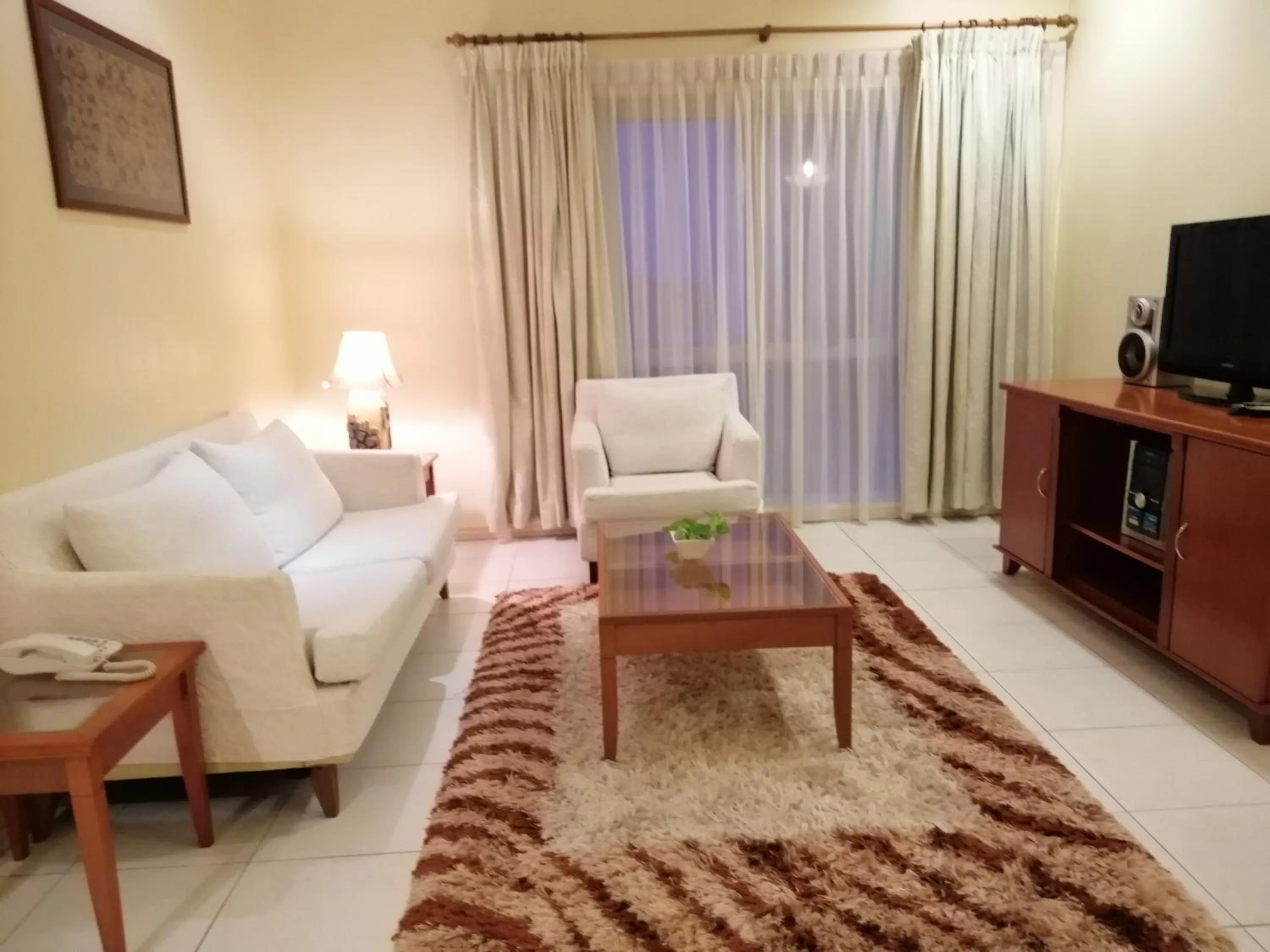 Communal lounge/ TV room, Bed in StayInn Gateway Hotel Apartment