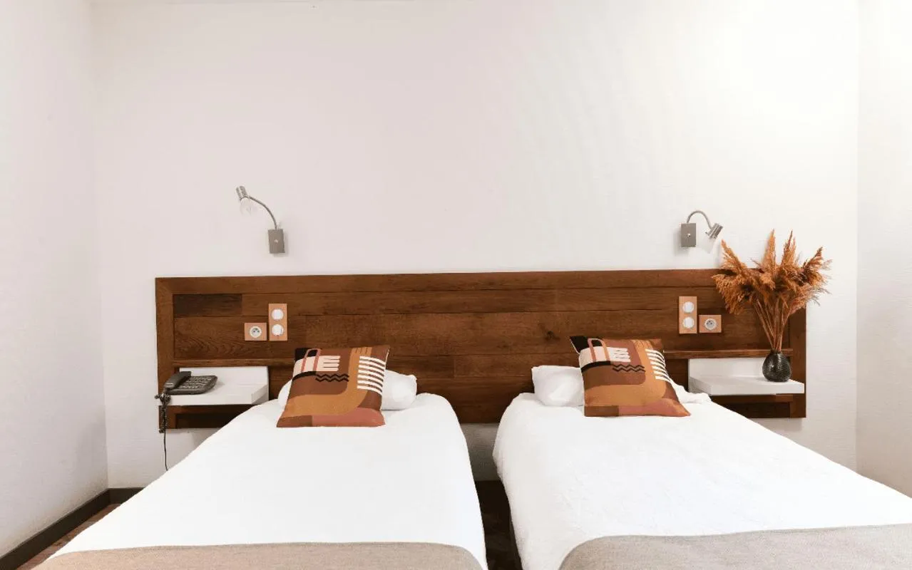 Bed in Logis Hôtel Etchemaïté