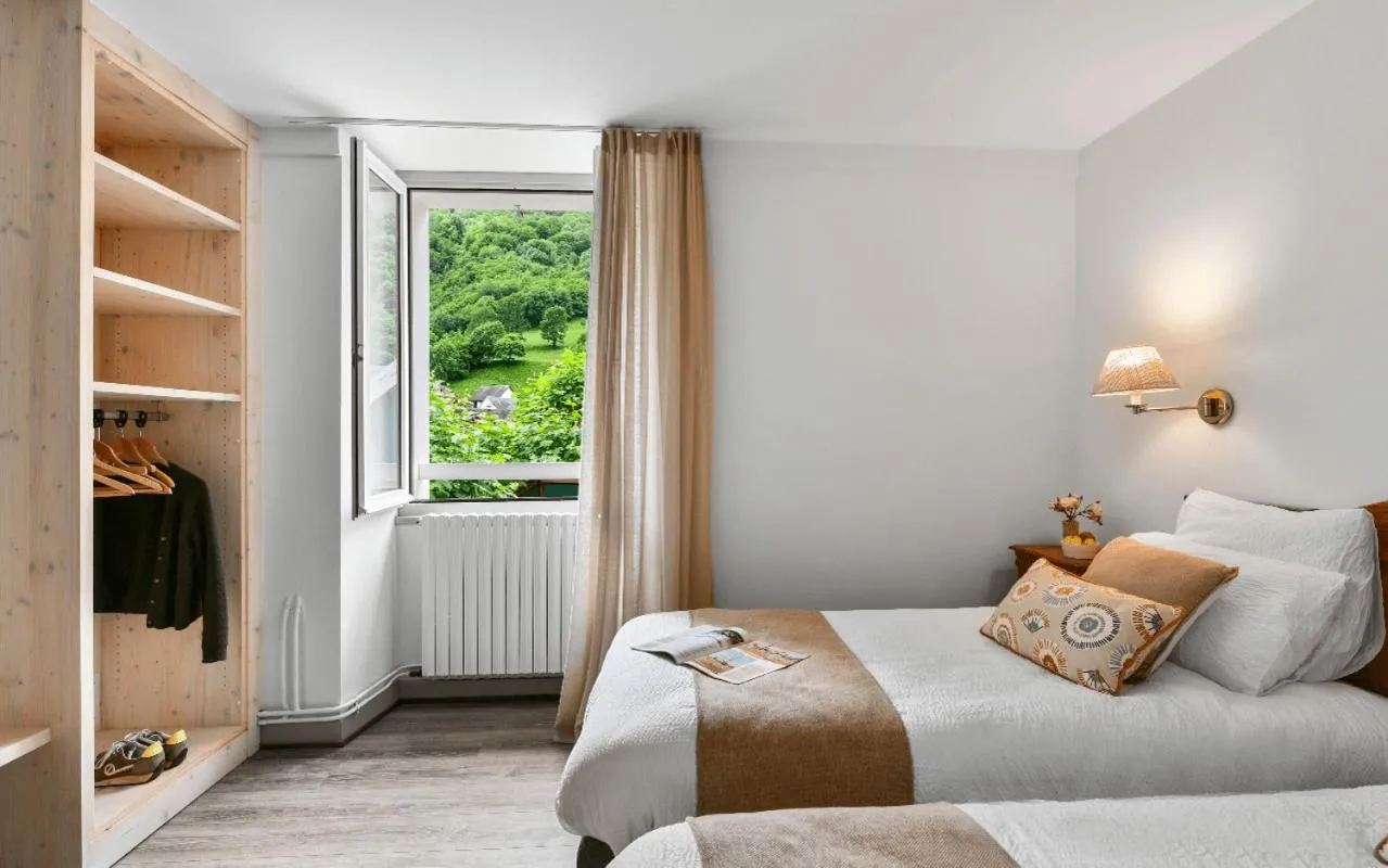 Bed in Logis Hôtel Etchemaïté