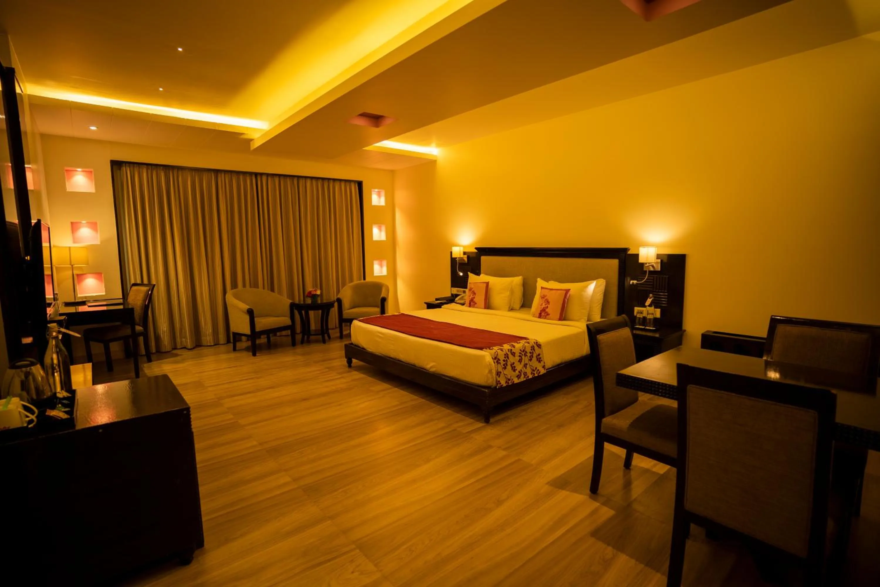 Seating area, Bed in Royal Orchid Central, Shimoga