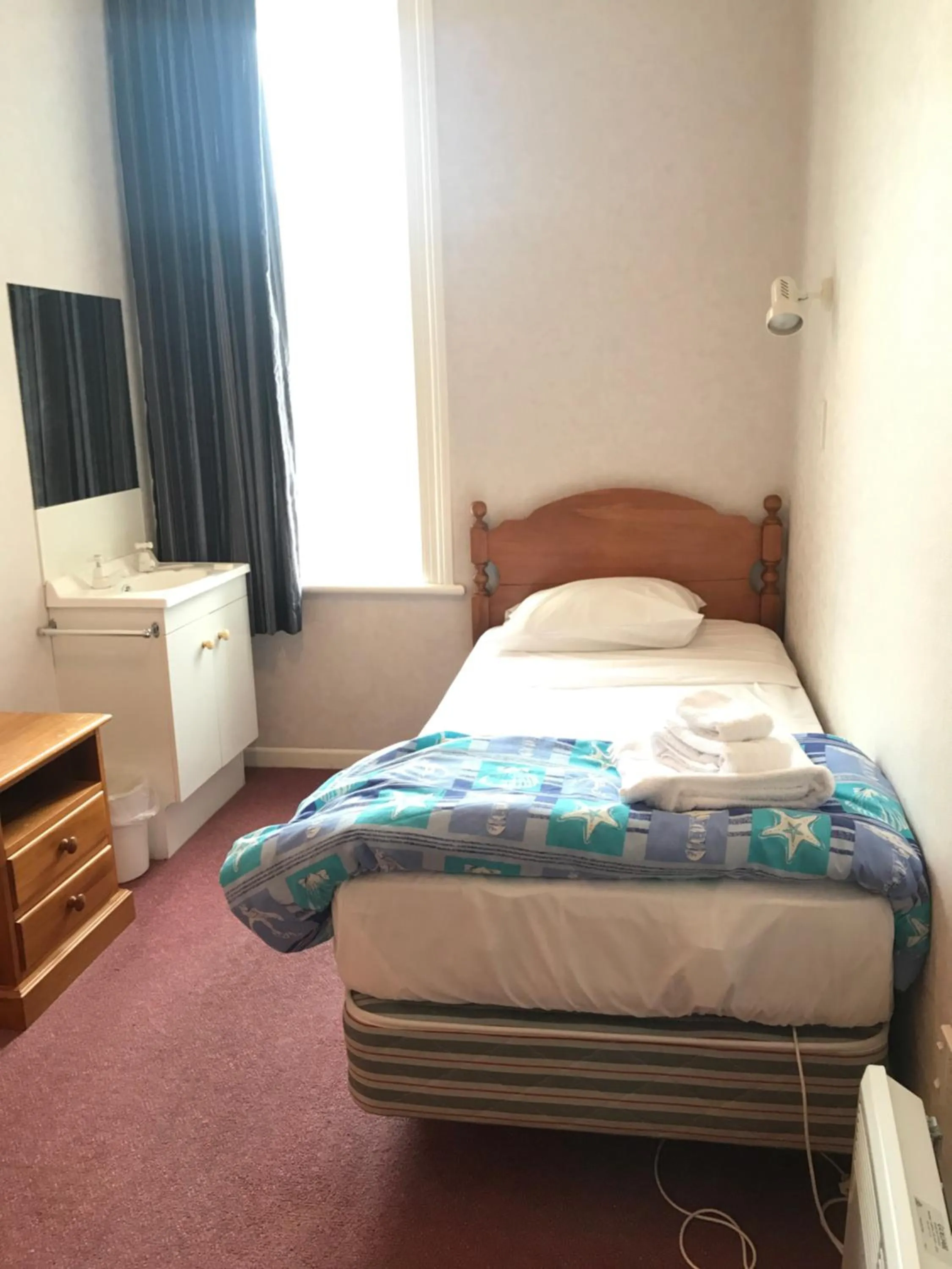 Bed in Criterion Club Hotel