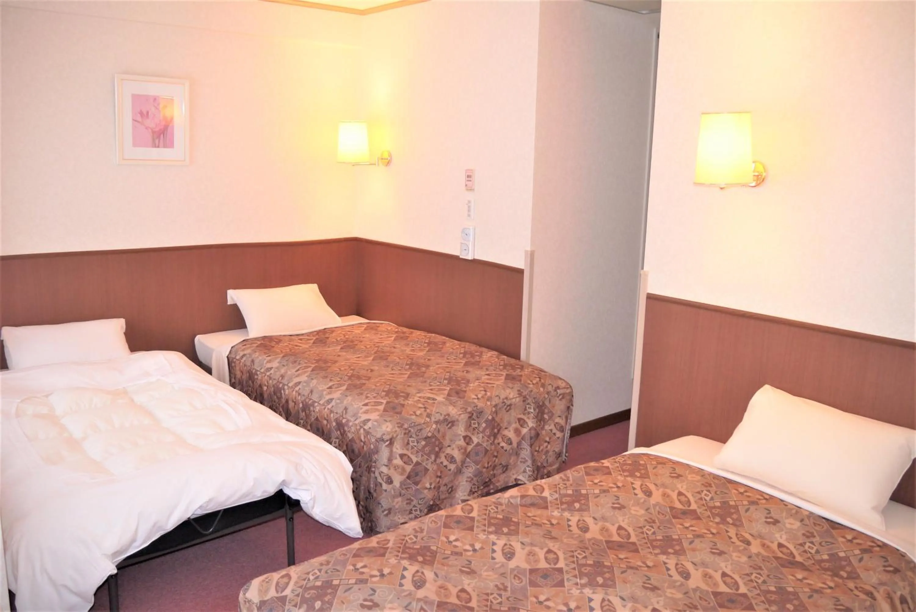Bed in U-Community Hotel