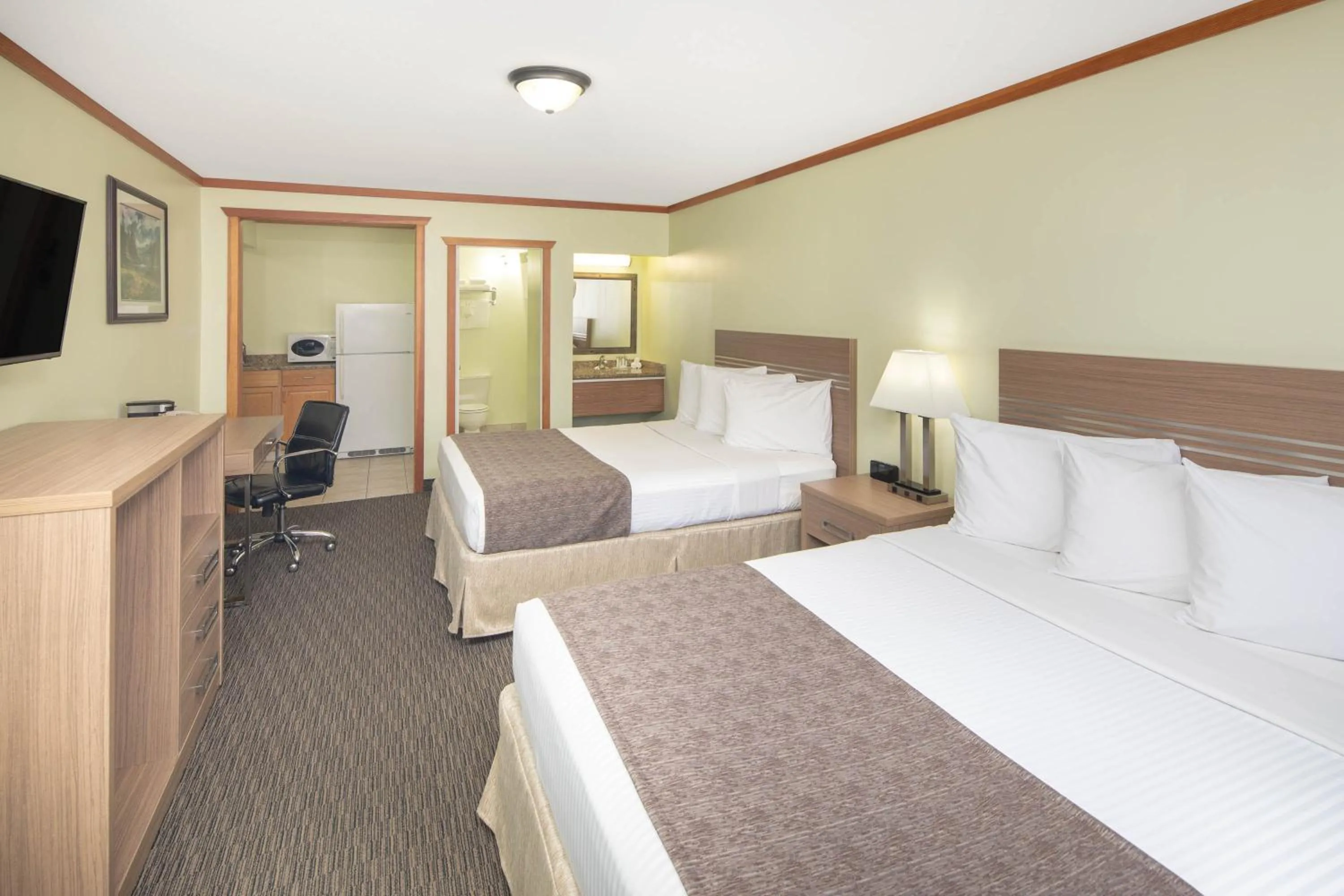 Kitchen or kitchenette, Bed in Travelodge by Wyndham Golden Sportsman Lodge