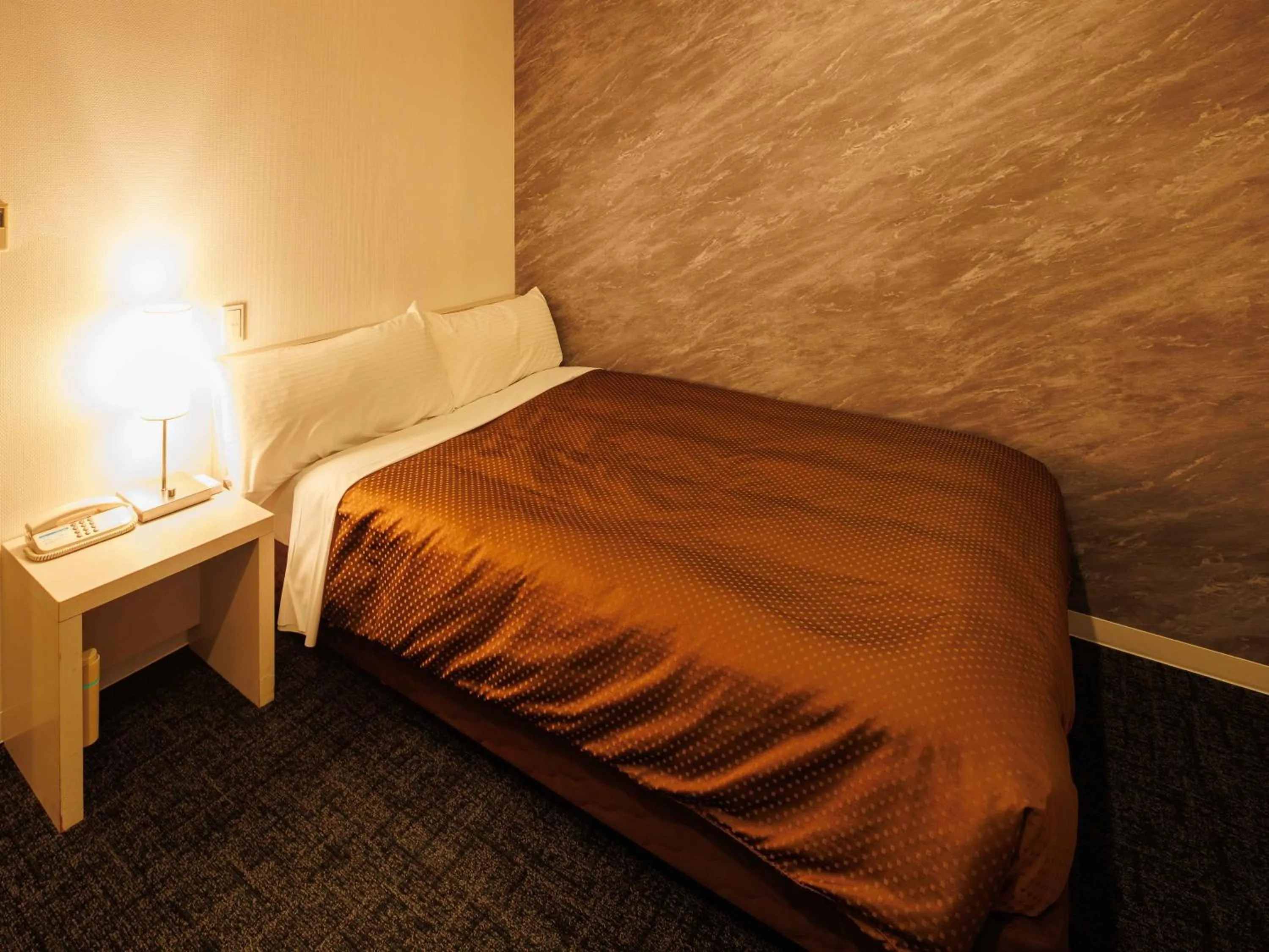 Bed in J Hotel Rinku