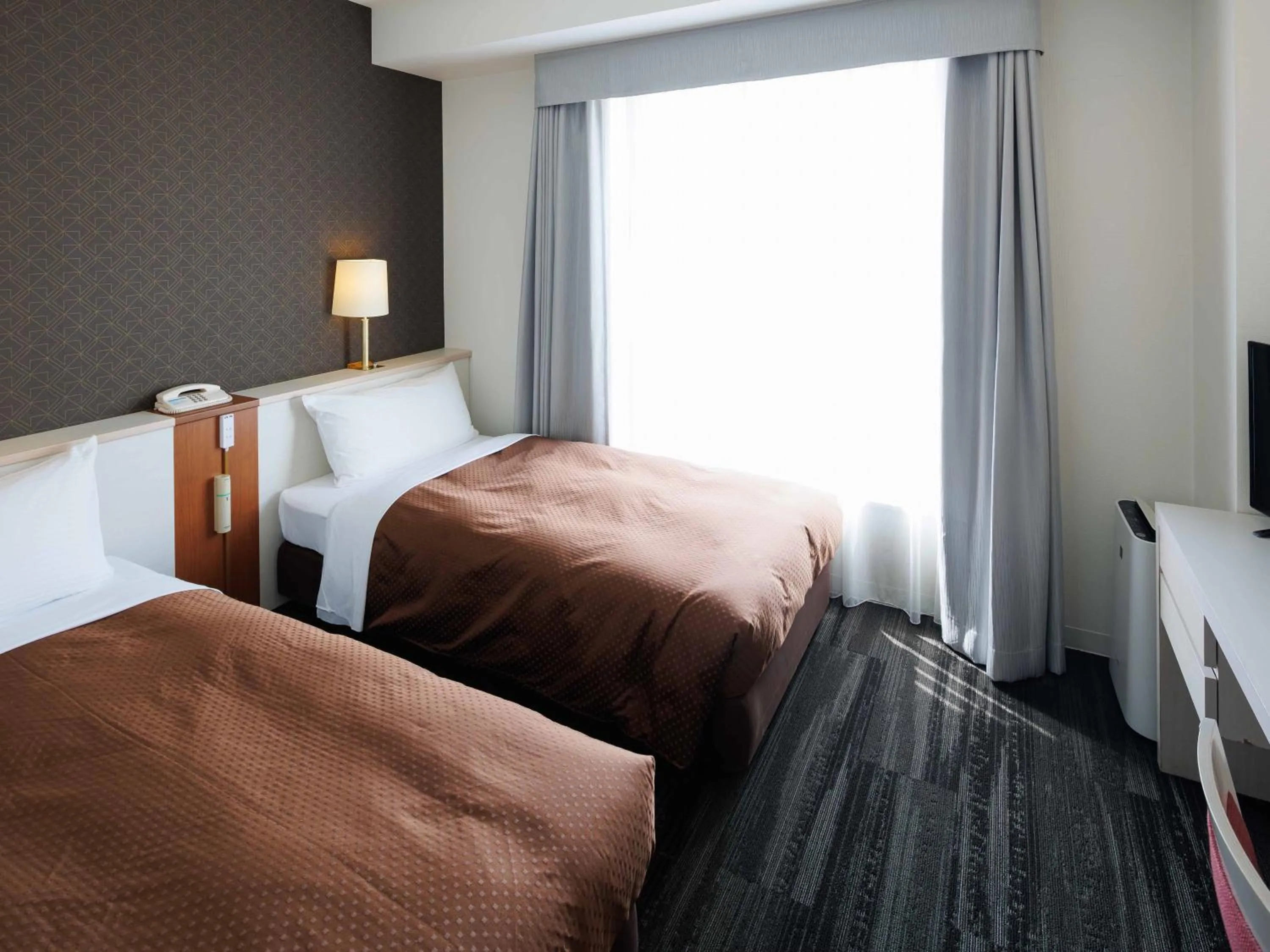 Bed in J Hotel Rinku