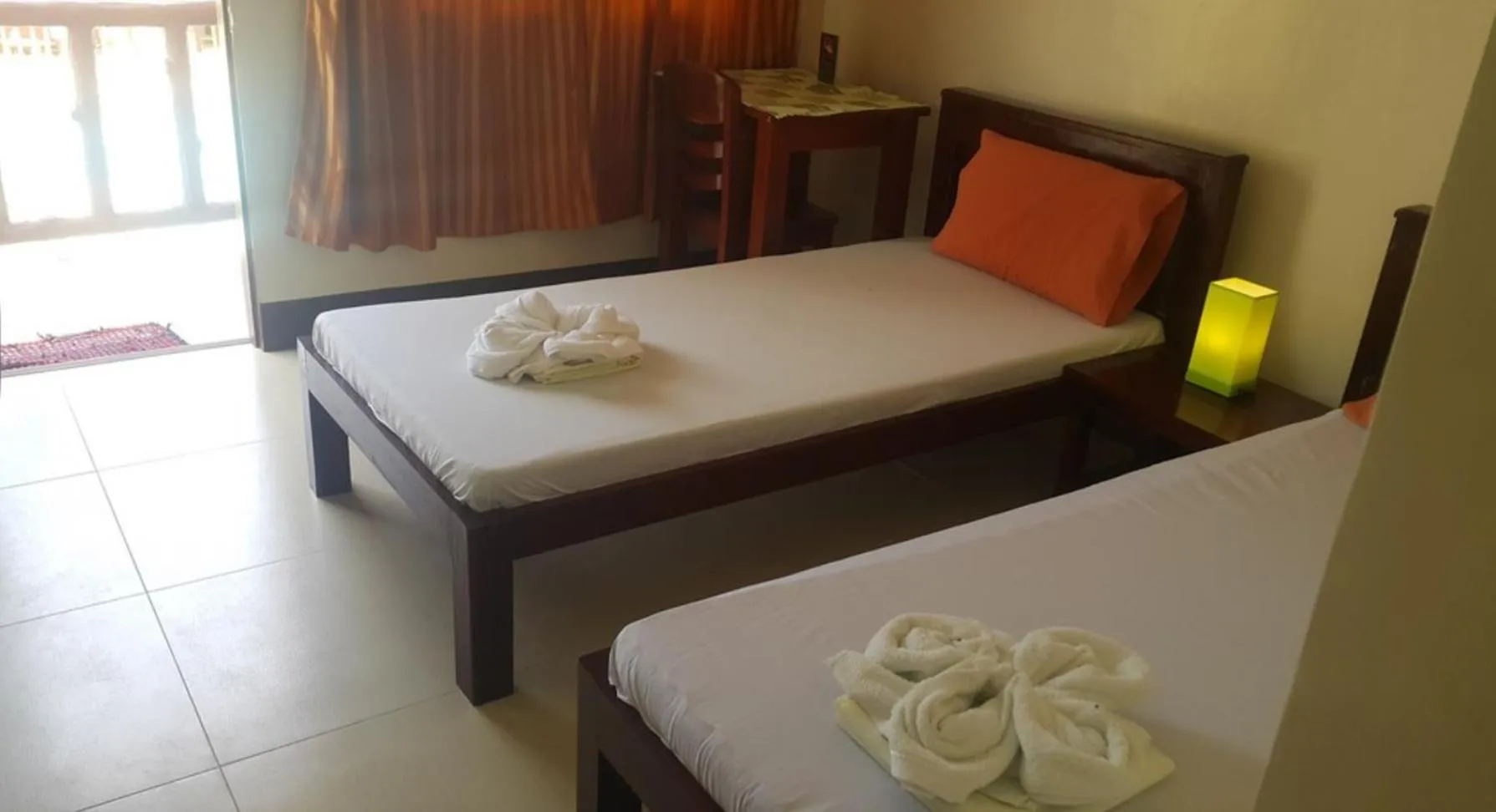 Bed in SLAM'S Garden Dive Resort