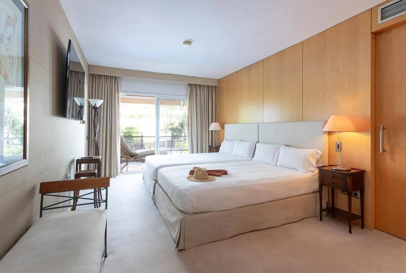 Bed in Suites del Mar Fenals Apartments