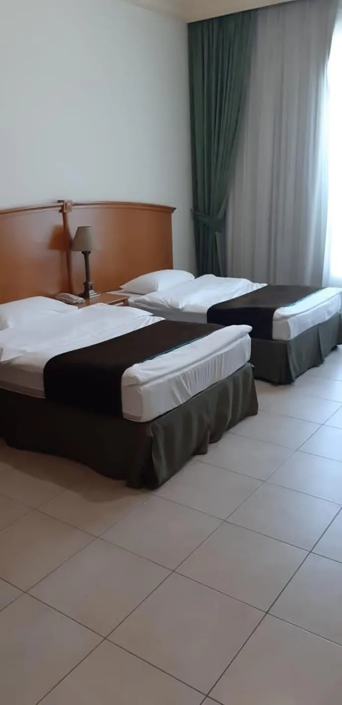 Bed in Platinum Hotel Apartments