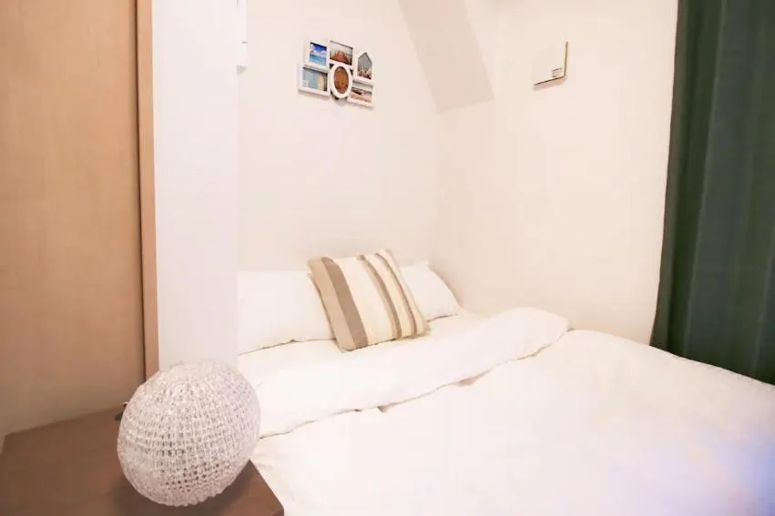 Bed in Uhome Kanda Hotel