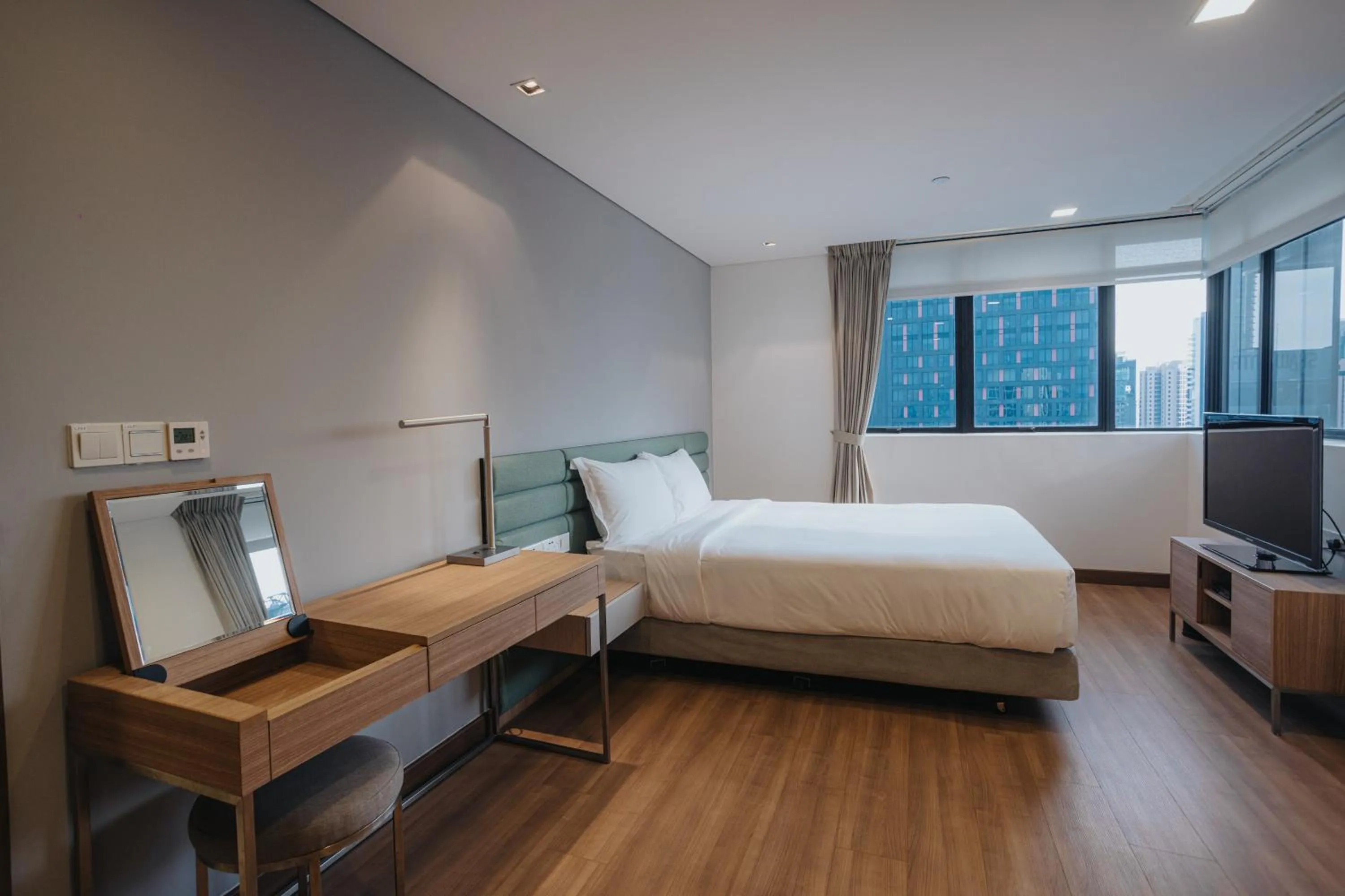 Photo of the whole room, Bed in Novotel Living Singapore Orchard