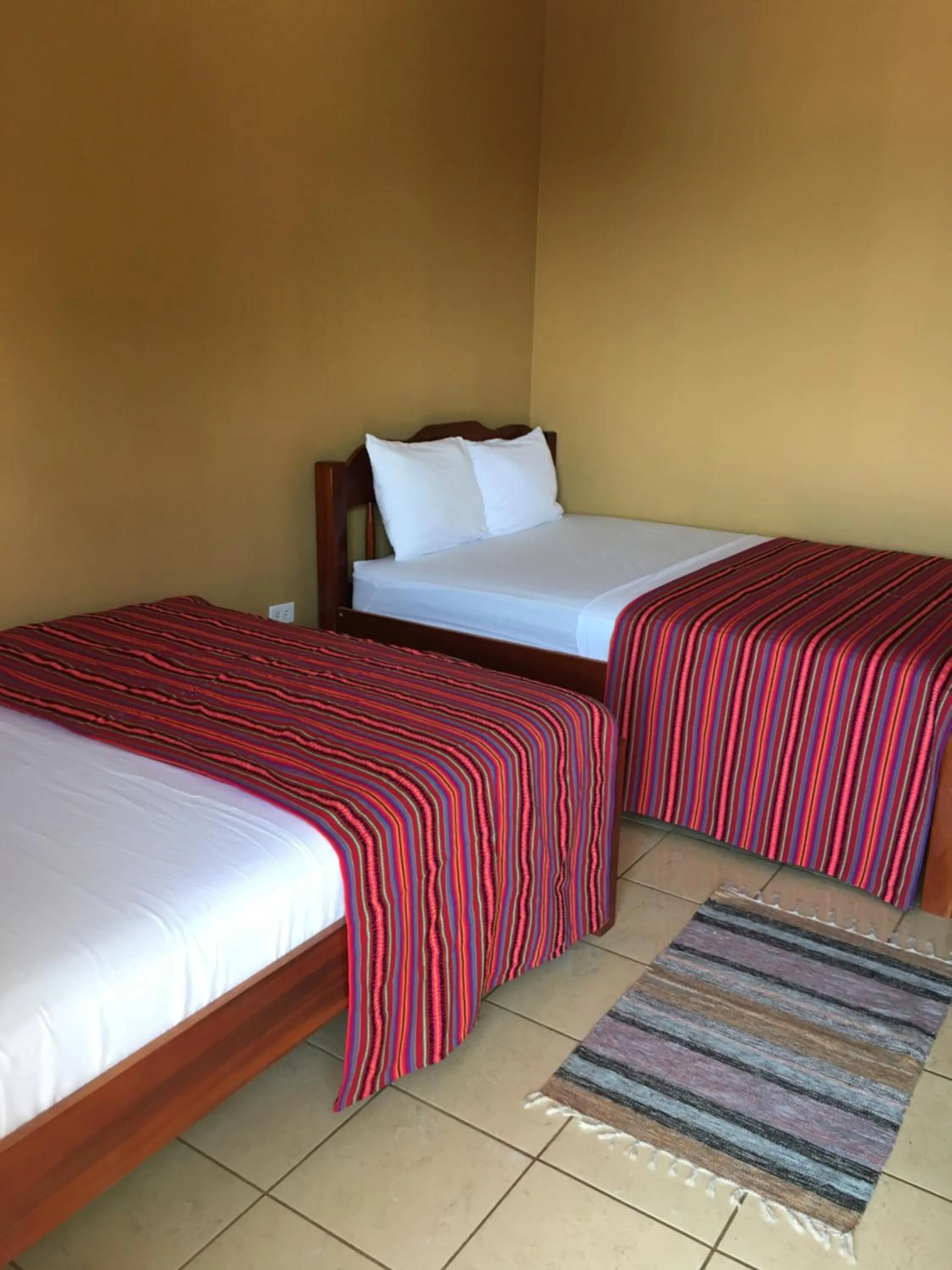 Bed in Ambergris Sunset Hotel