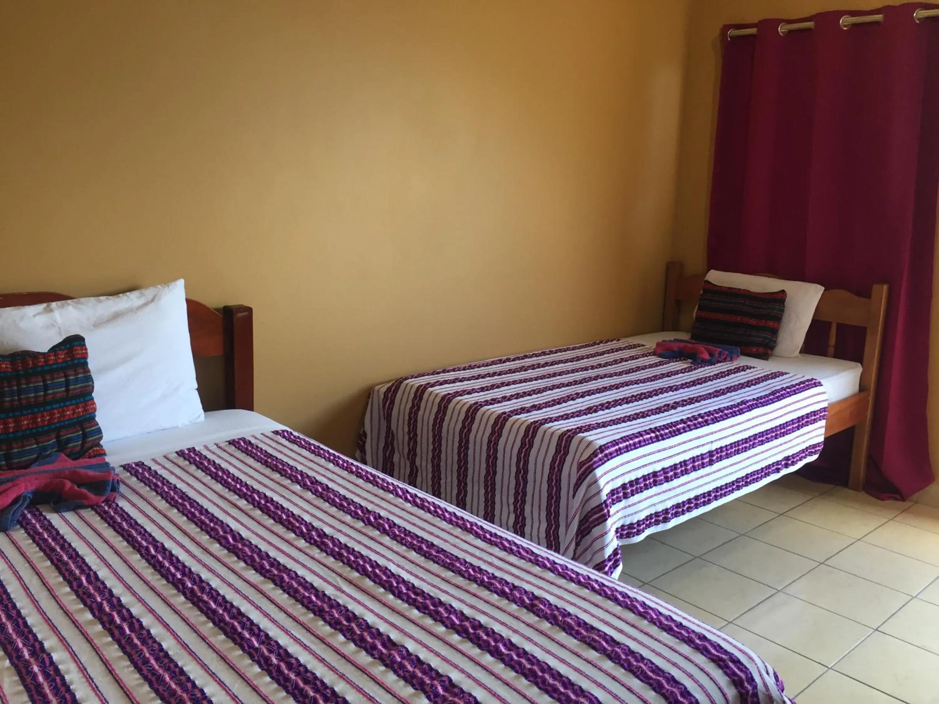 Bed in Ambergris Sunset Hotel