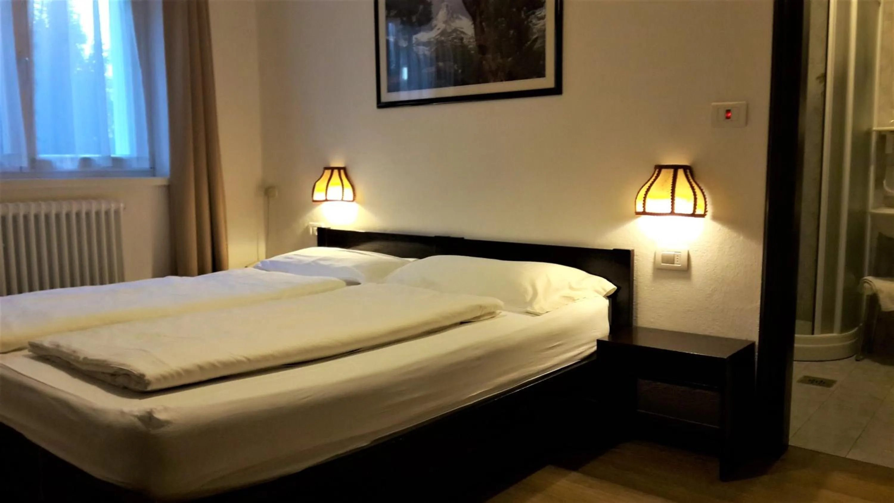 Photo of the whole room, Bed in Hotel Regina Delle Dolomiti