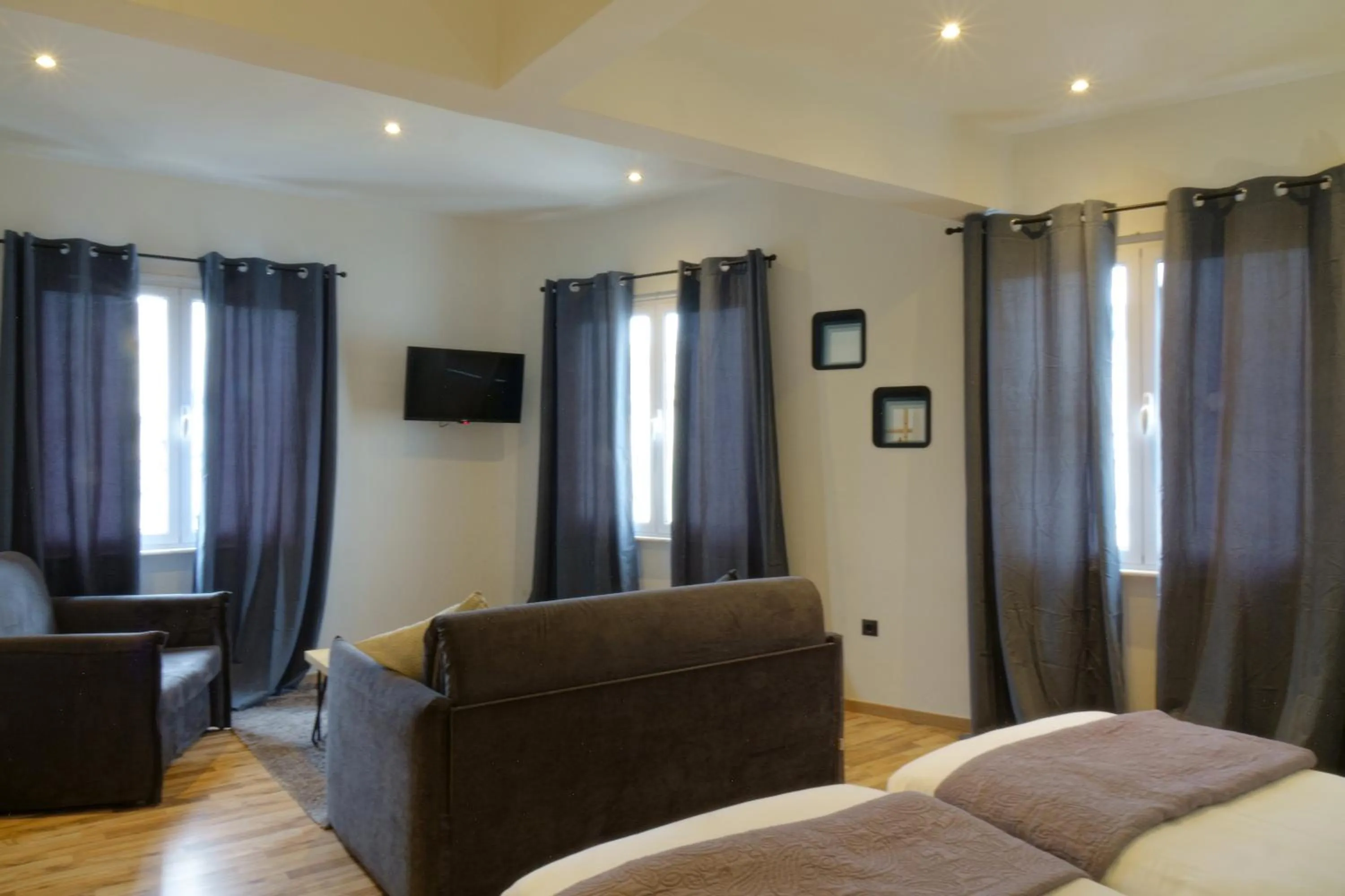 Living room, Bed in The Athens Version Luxury Suites