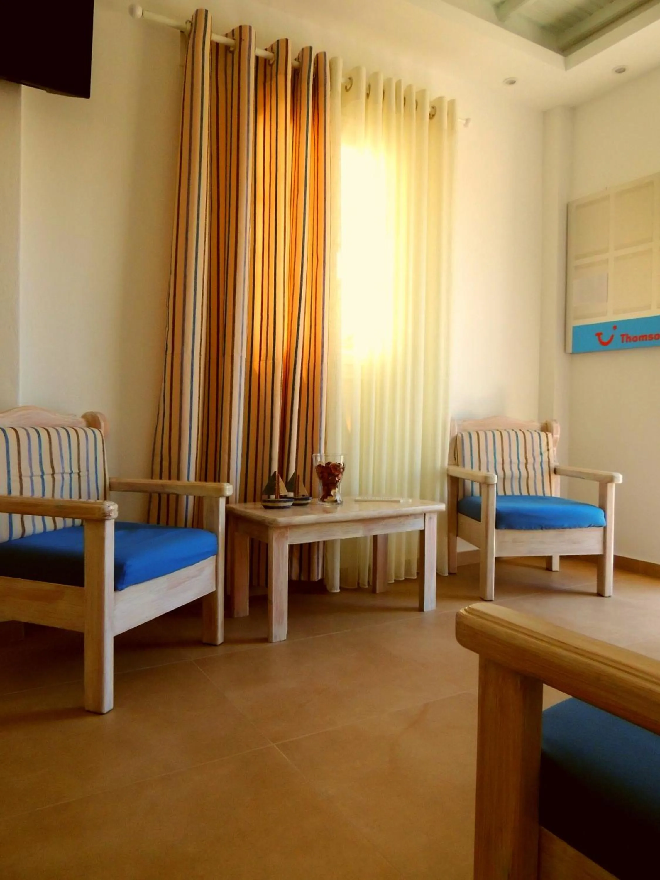 Seating area, Bed in Anemos Hotel & Apartments