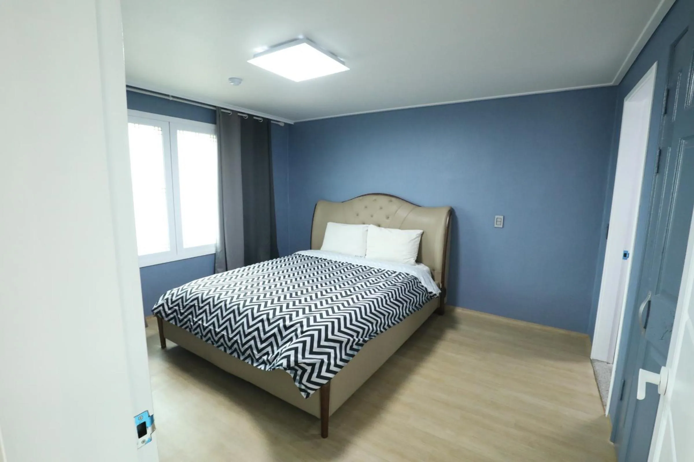 Bed in jeju Tovice Condo Ocean