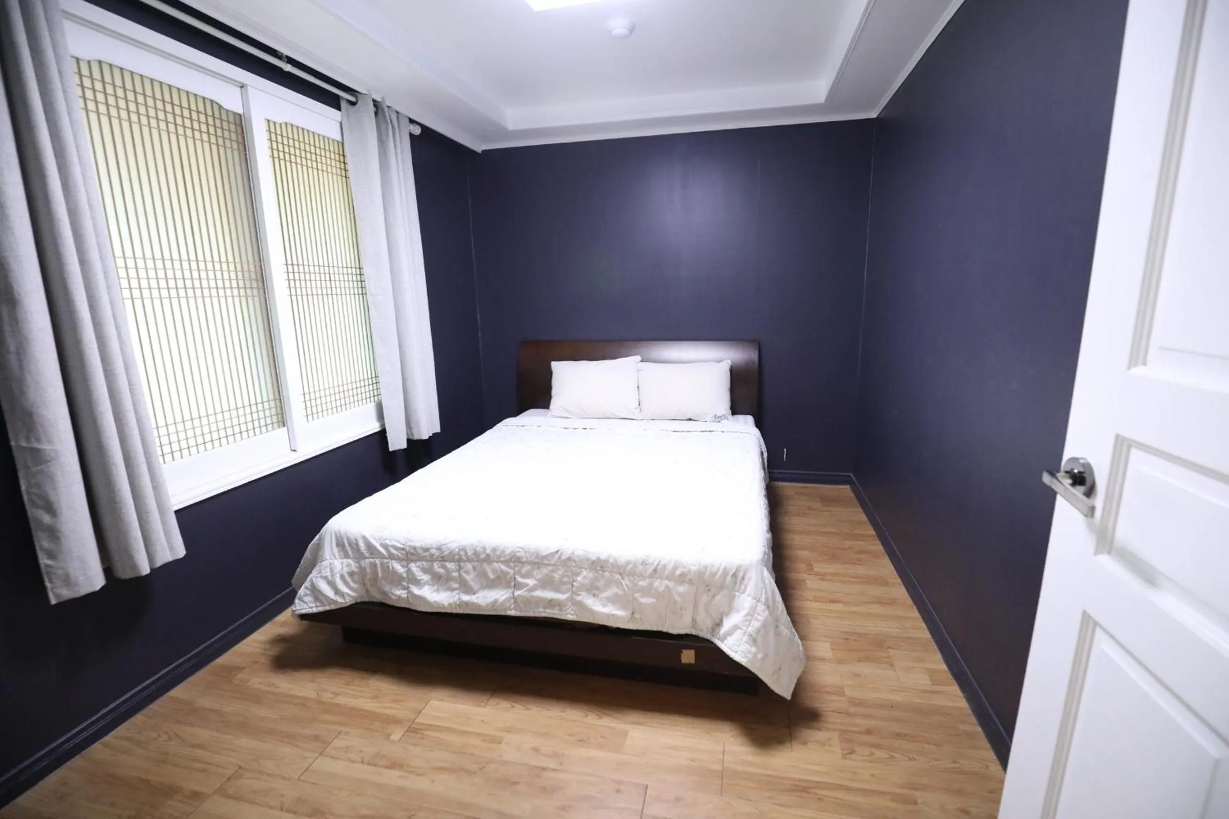 Bed in jeju Tovice Condo Ocean