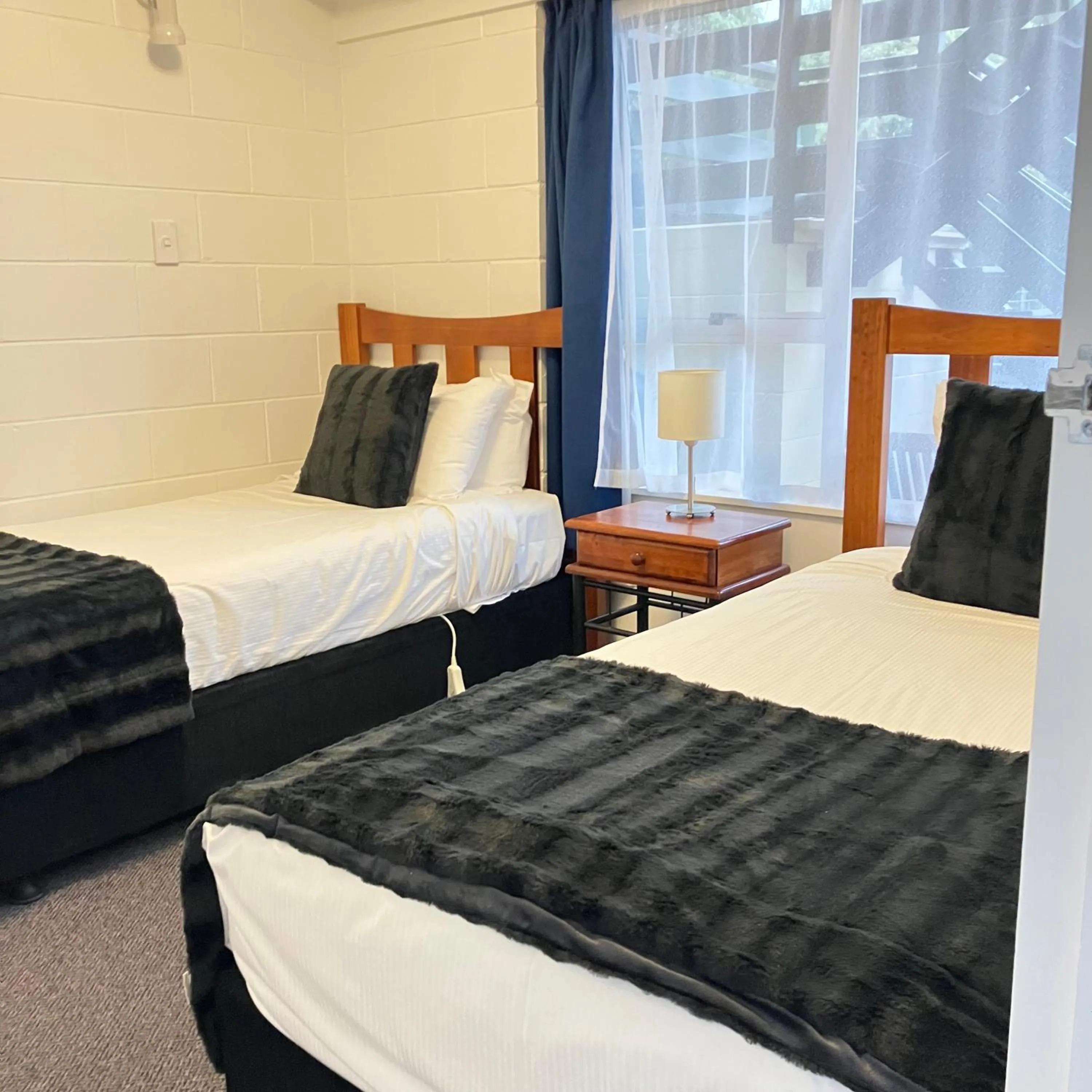 Bed in Kapiti Gateway Motel