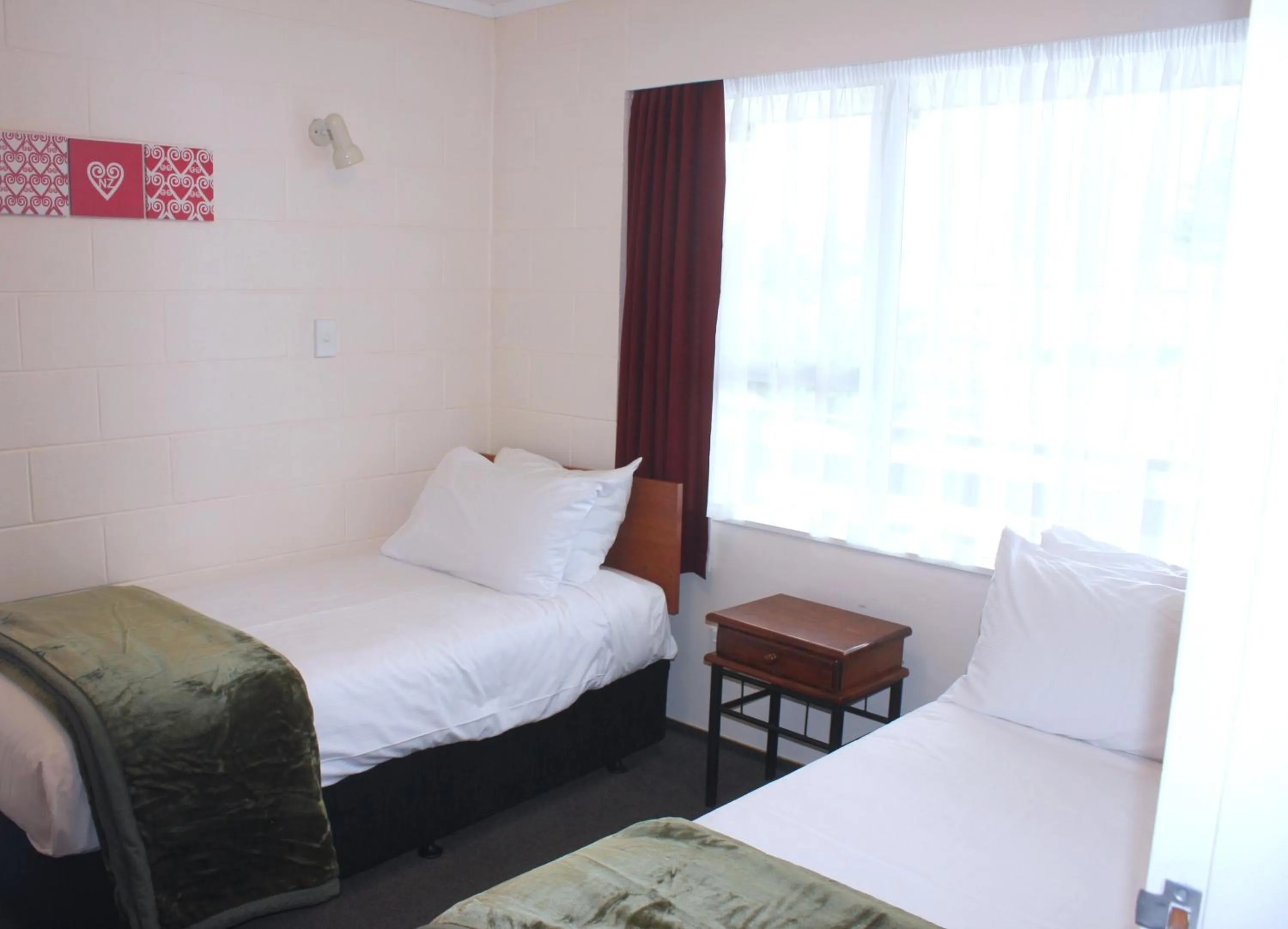 Bed in Kapiti Gateway Motel