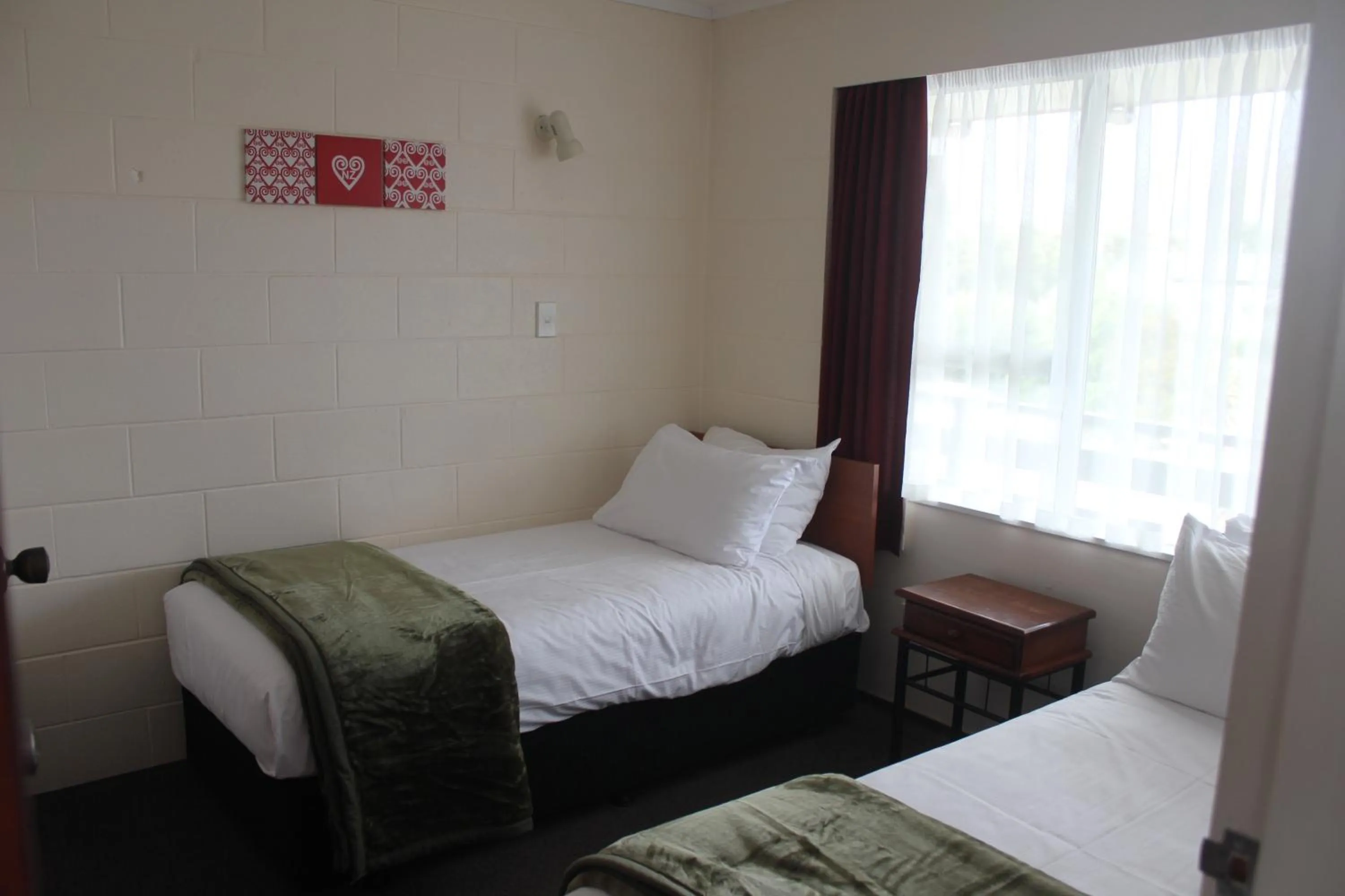 Bed in Kapiti Gateway Motel