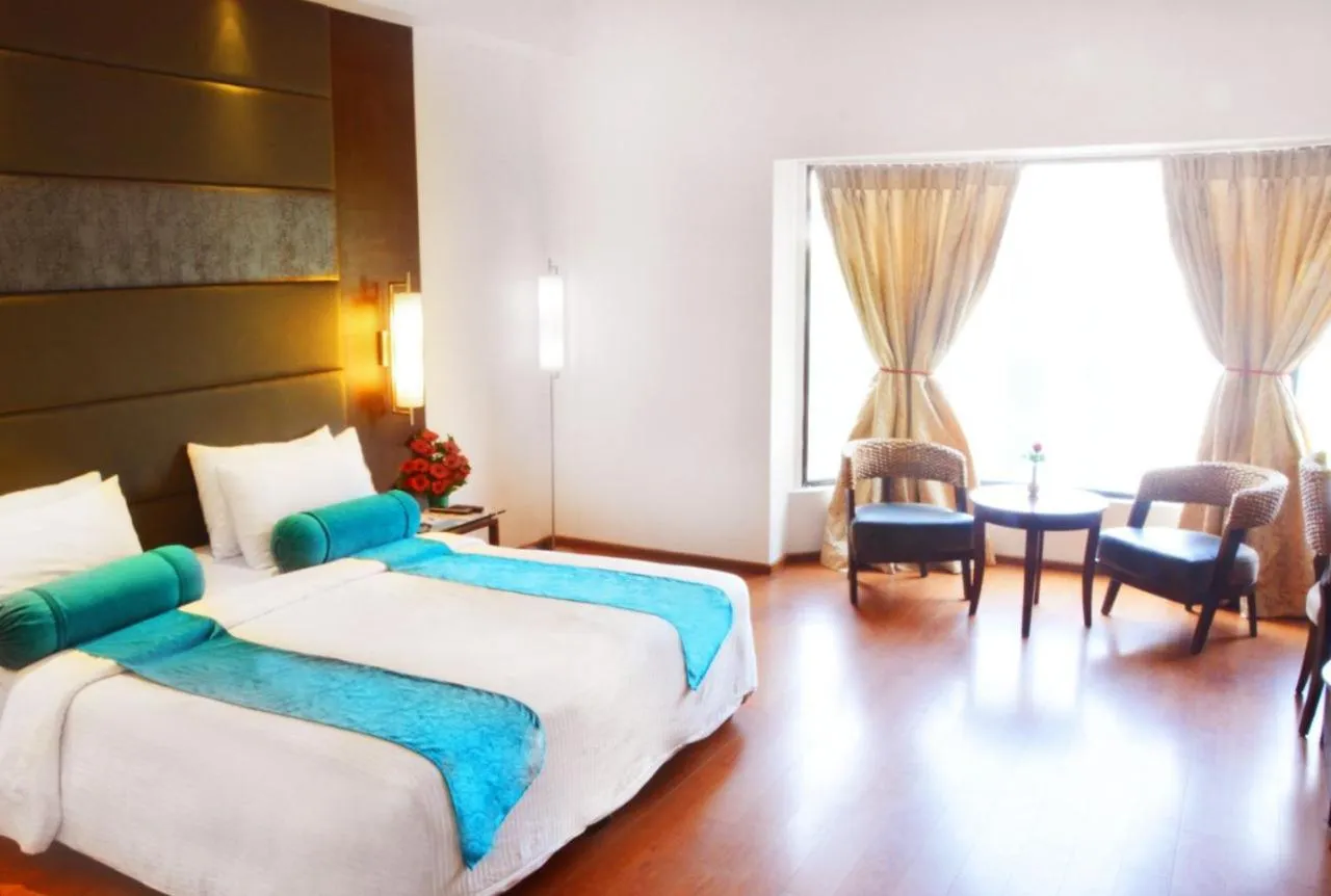 Bed in Ashraya International Hotel