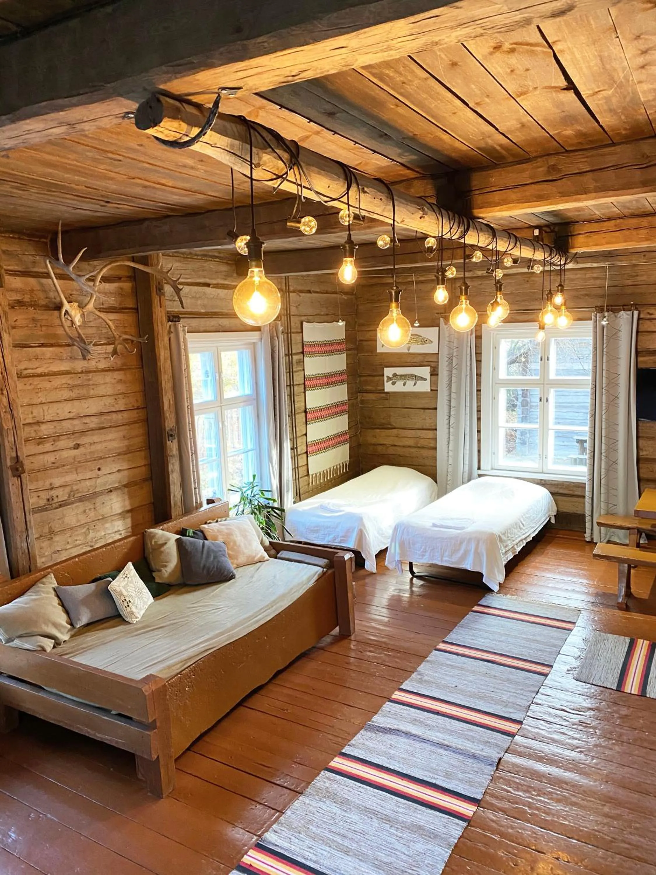 Photo of the whole room, Bed in LAURI Historical Log House Manor