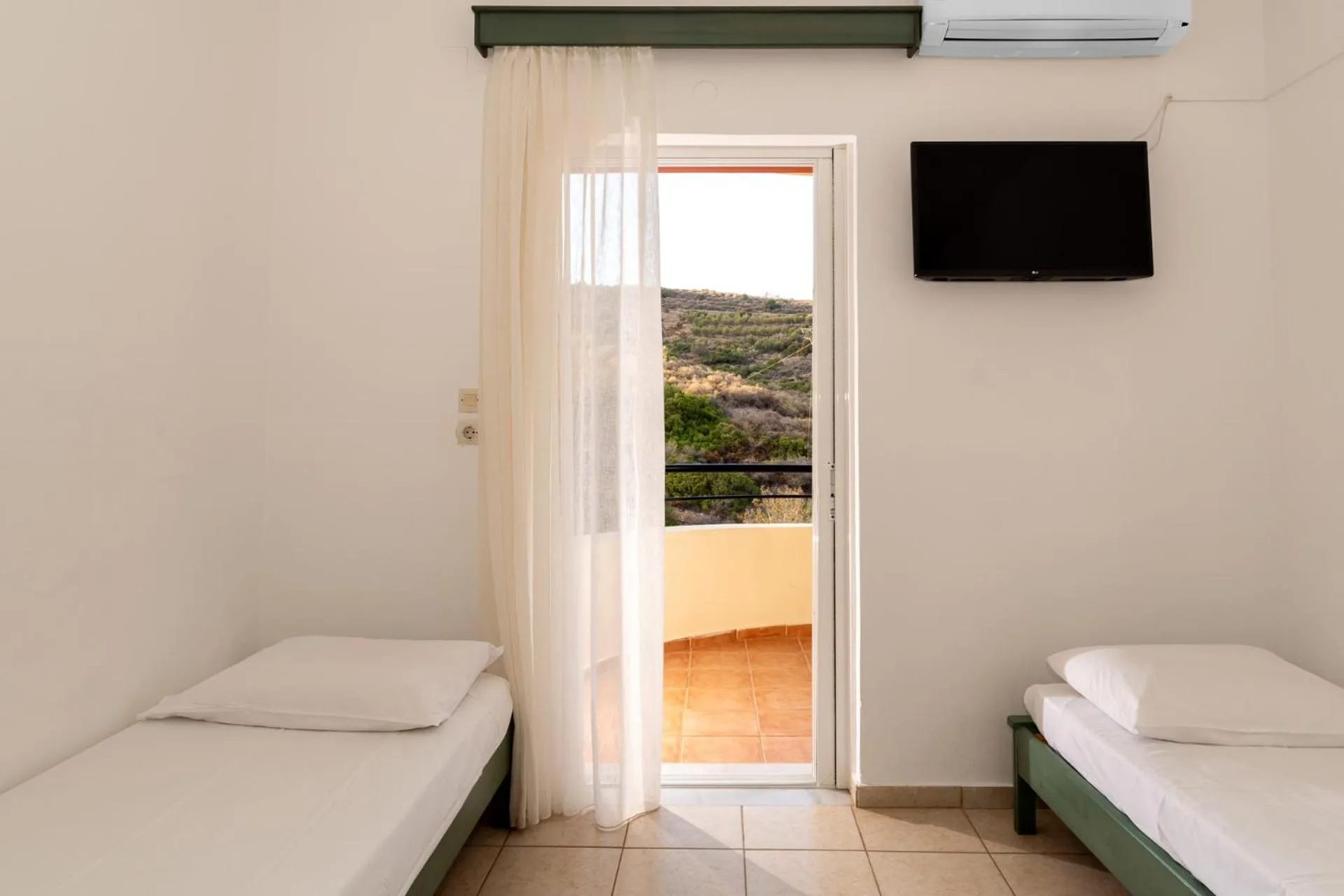 Bed in Elpis Studio Apartments