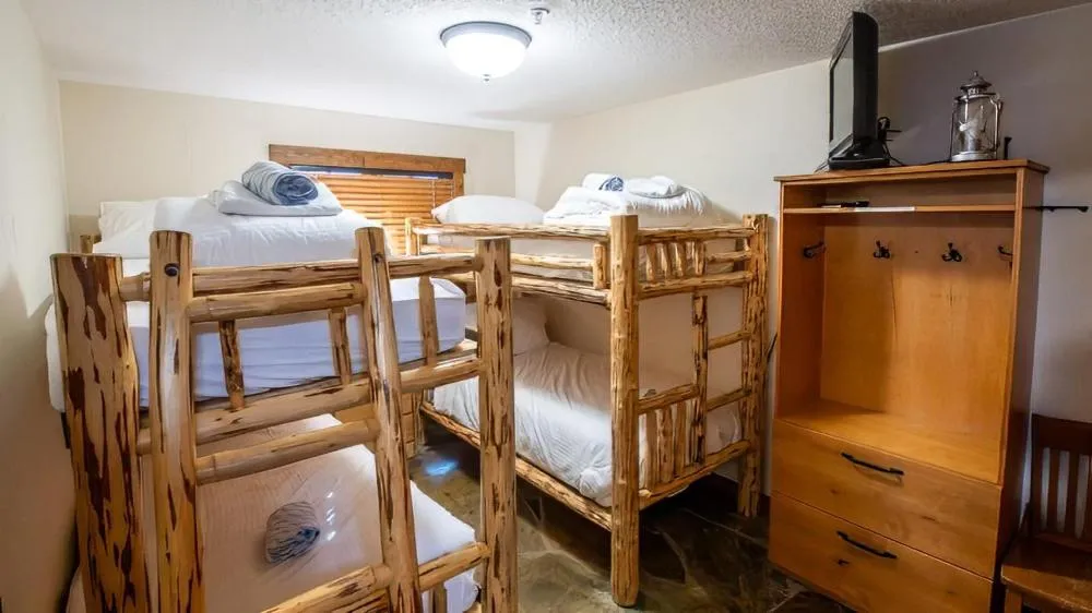 Bed in Snow Creek Cabins by Fernie Lodging Co