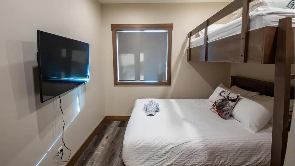 Bed in Snow Creek Cabins by Fernie Lodging Co