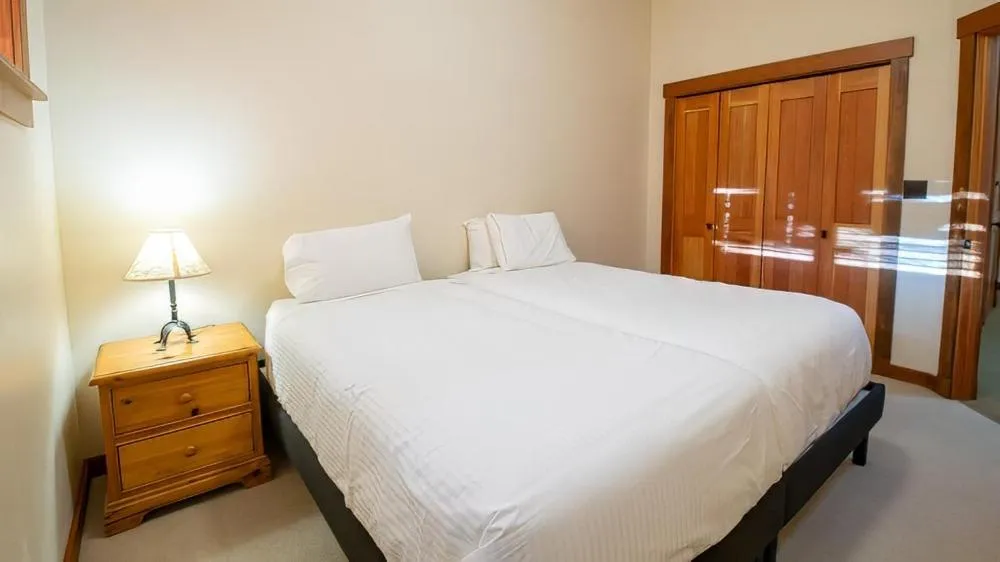 Bed in Snow Creek Cabins by Fernie Lodging Co