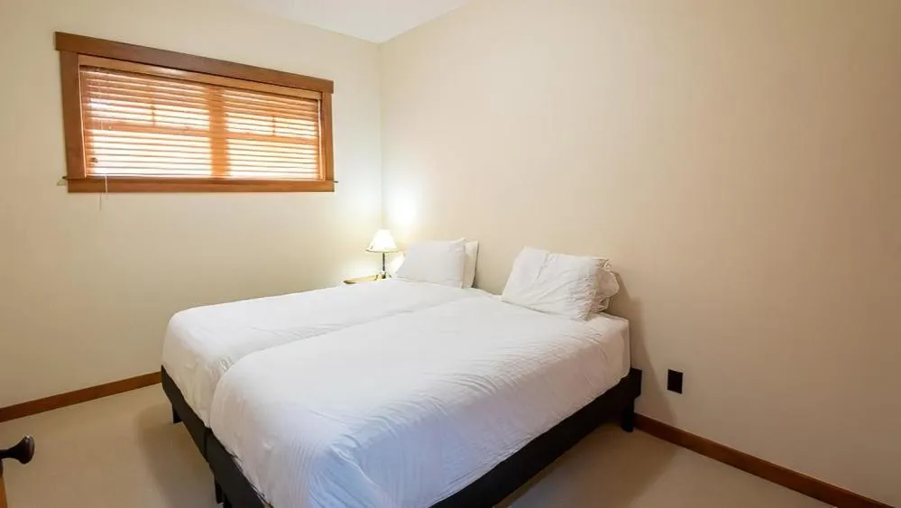 Bed in Snow Creek Cabins by Fernie Lodging Co