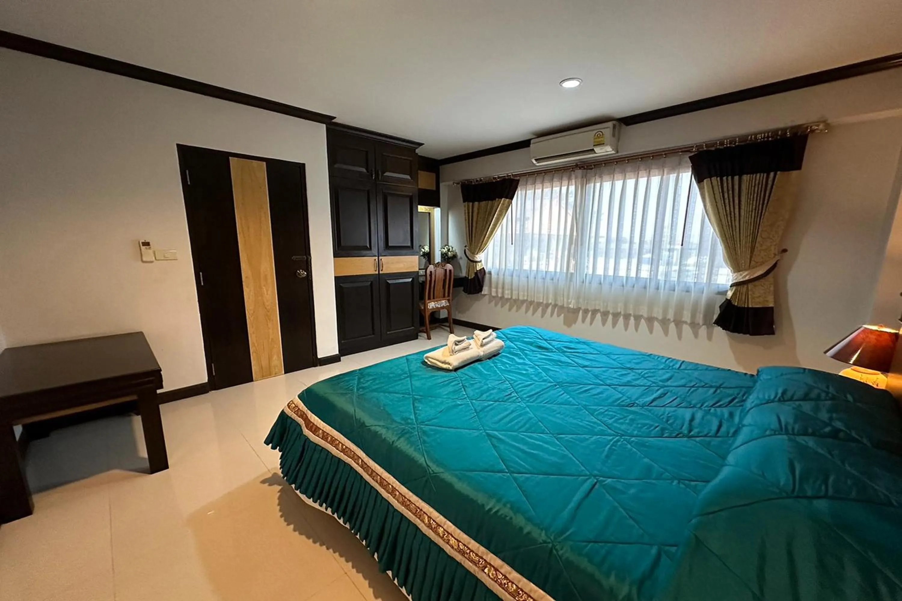 Bed in Chiangrai Grand Room Hotel