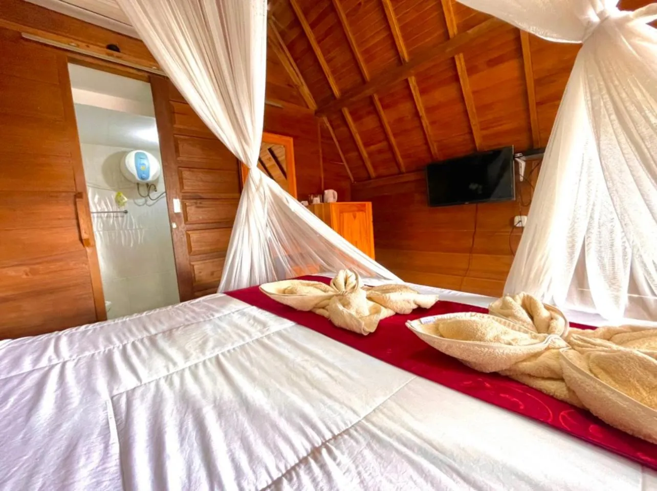 Bed in Ayu Laba Beach Villa and Resto