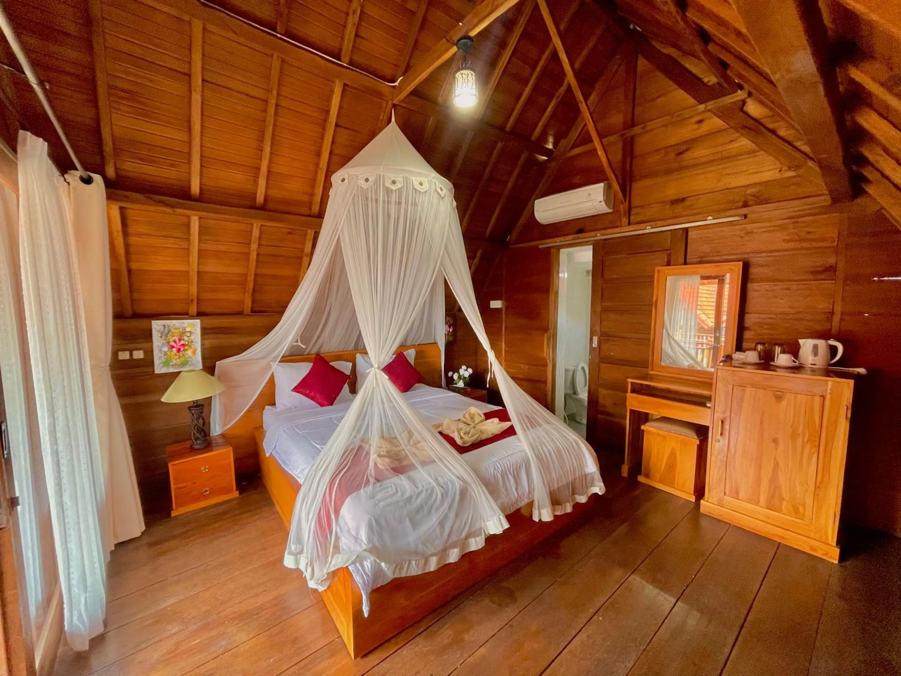 Bed in Ayu Laba Beach Villa and Resto